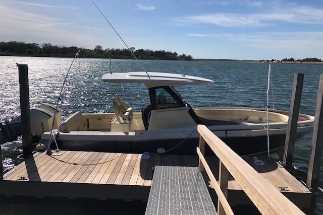 2023 Chris-Craft Catalina 30 docked on a sunny day by the water.