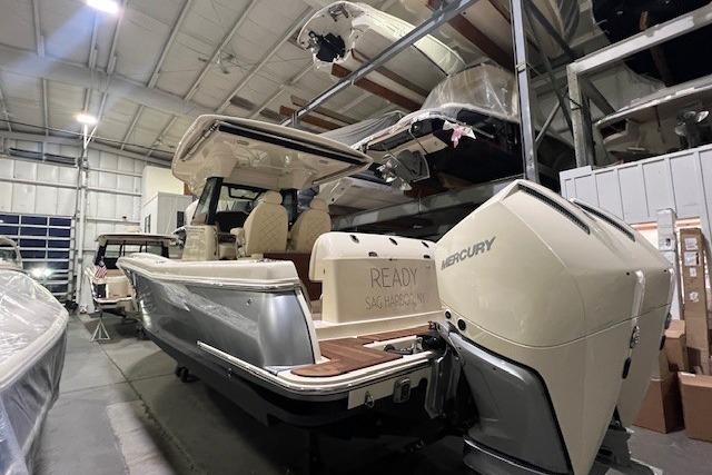 2023 Chris-Craft Catalina 30 boat in a storage facility, featuring a Mercury engine.