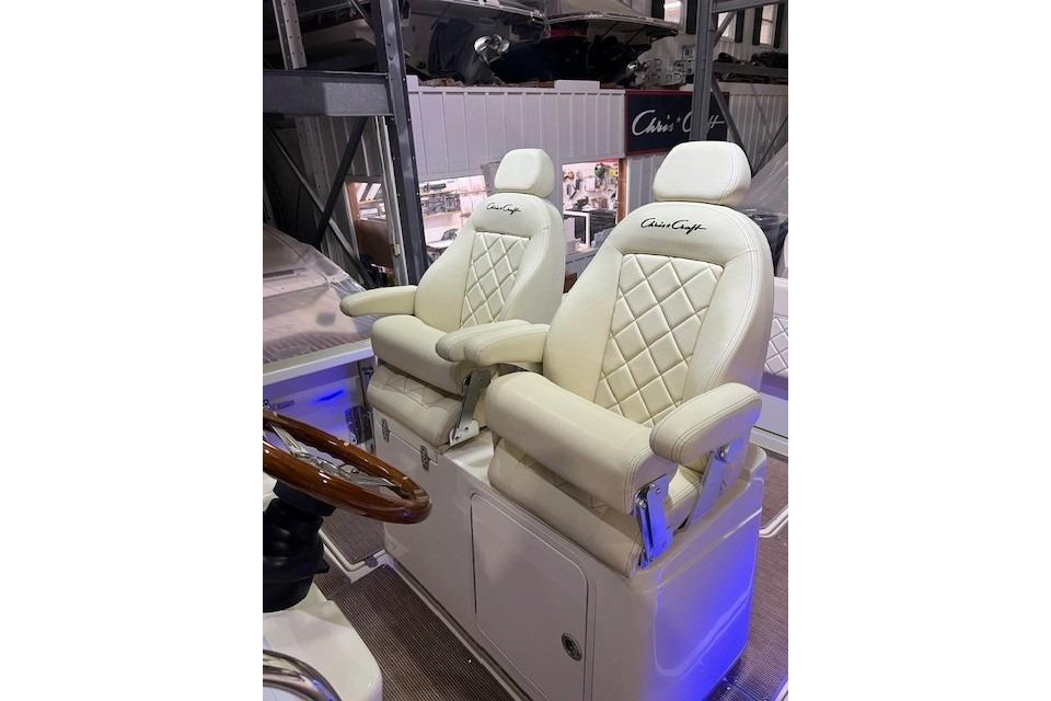 Luxury seating on 2023 Chris-Craft Catalina 30 boat, featuring elegant white upholstery.