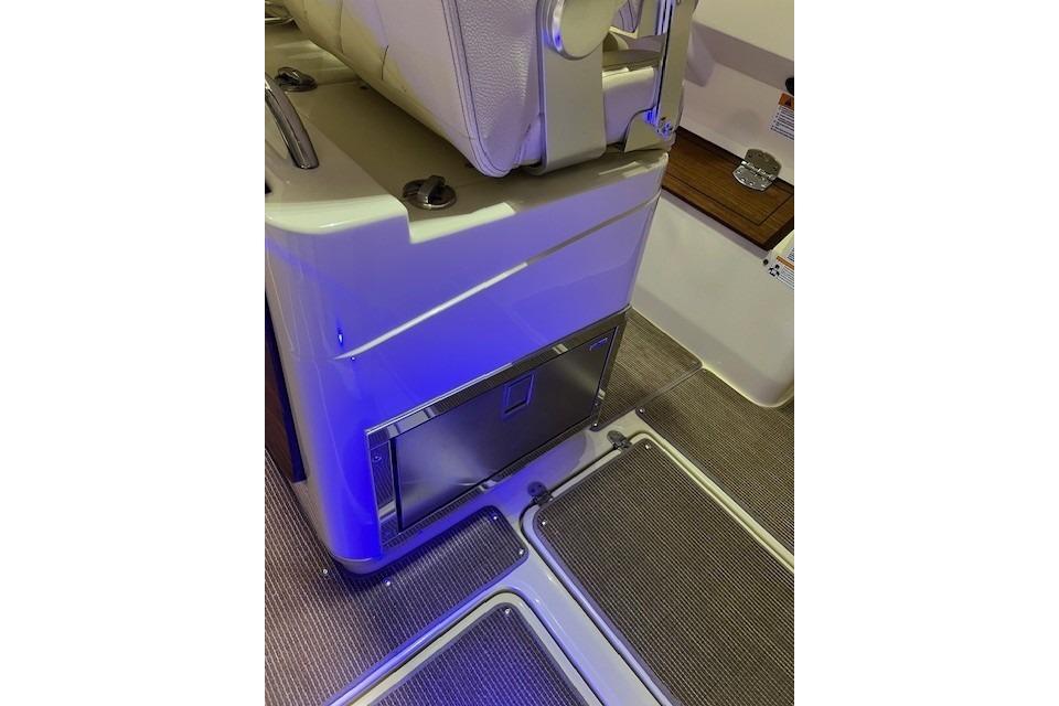 2023 Chris-Craft Catalina 30 interior with blue lighting and seating area.