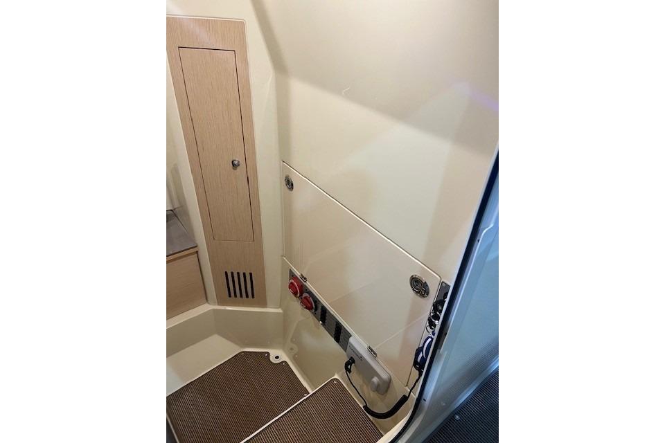 2023 Chris-Craft Catalina 30 interior with storage compartments and control panel.