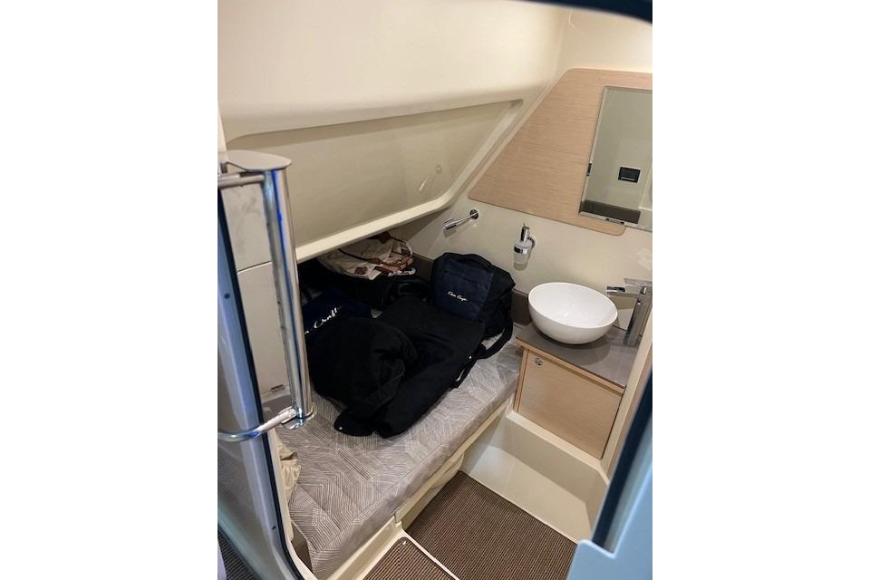 2023 Chris-Craft Catalina 30 cabin interior with bed and sink.