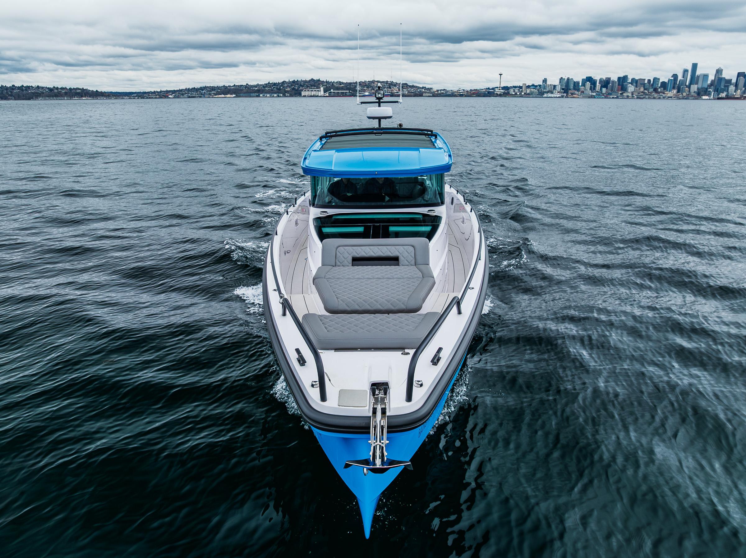 Axopar-37xc  Wetbar 2021-AQVAVIT WA-US-2021 Axopar 37xc Wetbar boat on open water with city skyline in background.-9703795