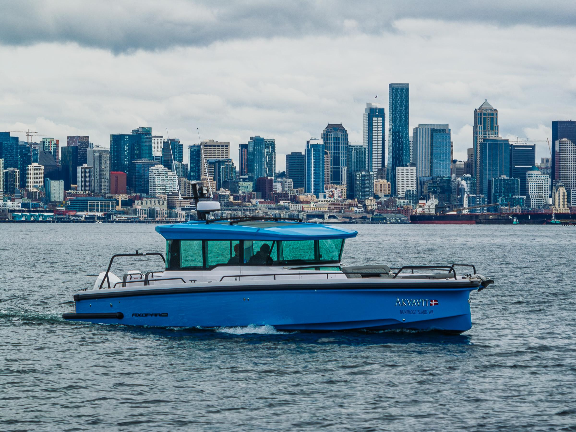 Axopar-37xc  Wetbar 2021-AQVAVIT WA-US-2021 Axopar 37xc Wetbar boat cruising with city skyline in the background.-9703795 | Thumbnail