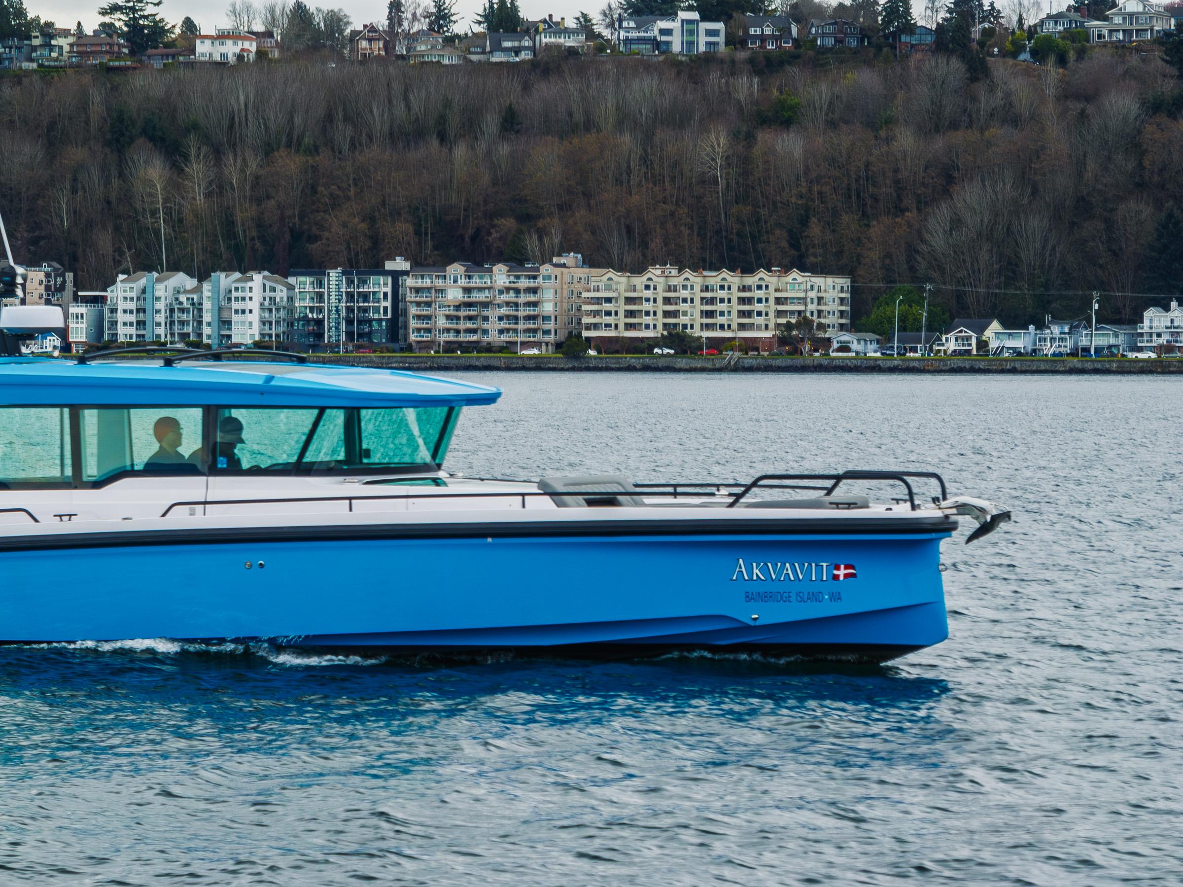 Axopar-37xc  Wetbar 2021-AQVAVIT WA-US-2021 Axopar 37xc Wetbar boat cruising near waterfront buildings.-9703795 | Thumbnail