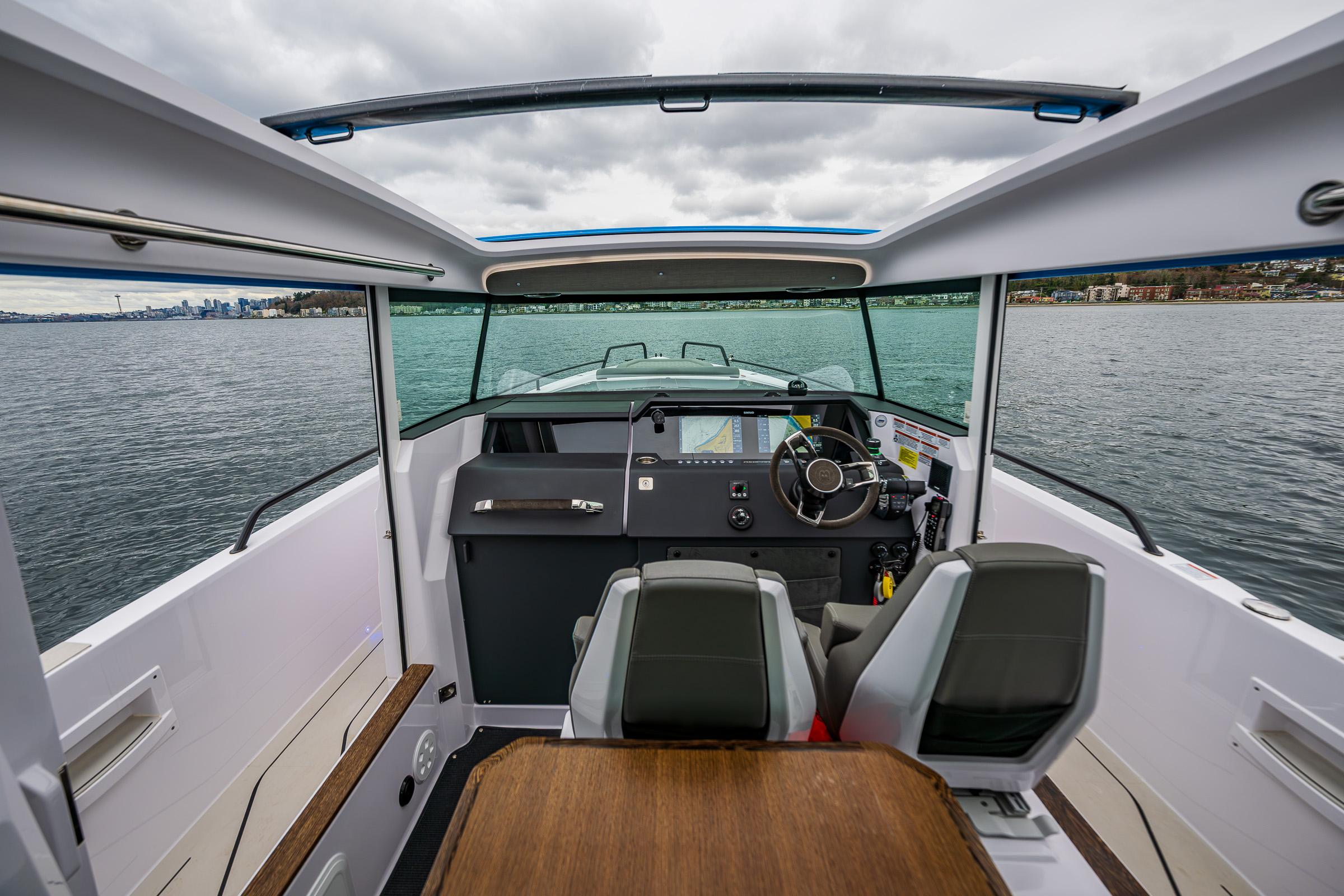 Axopar-37xc  Wetbar 2021-AQVAVIT WA-US-2021 Axopar 37xc Wetbar boat interior with steering wheel and seating on water.-9703795 | Thumbnail