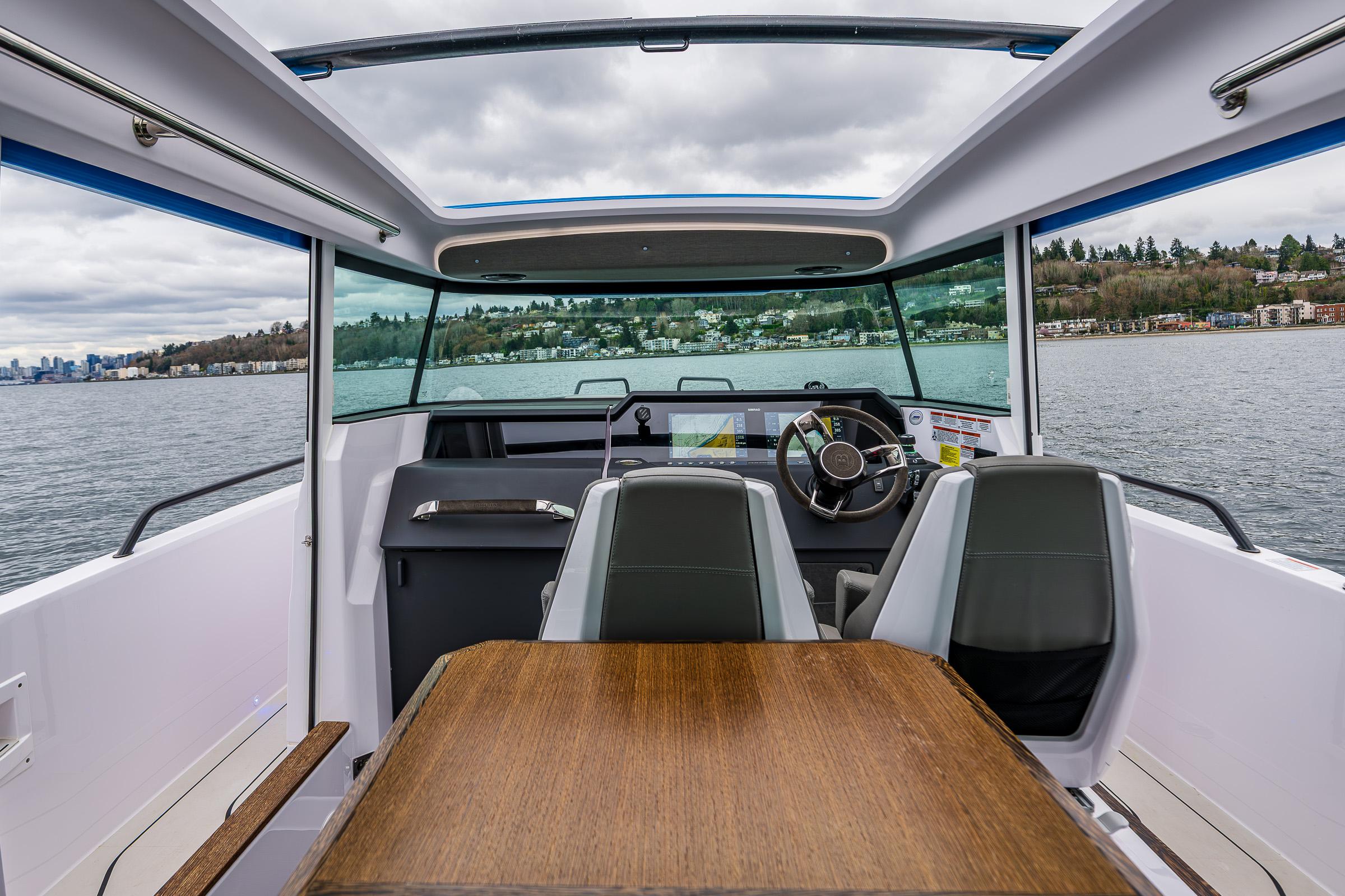 Axopar-37xc  Wetbar 2021-AQVAVIT WA-US-Interior view of 2021 Axopar 37xc Wetbar boat with seating and table on a lake.-9703795 | Thumbnail