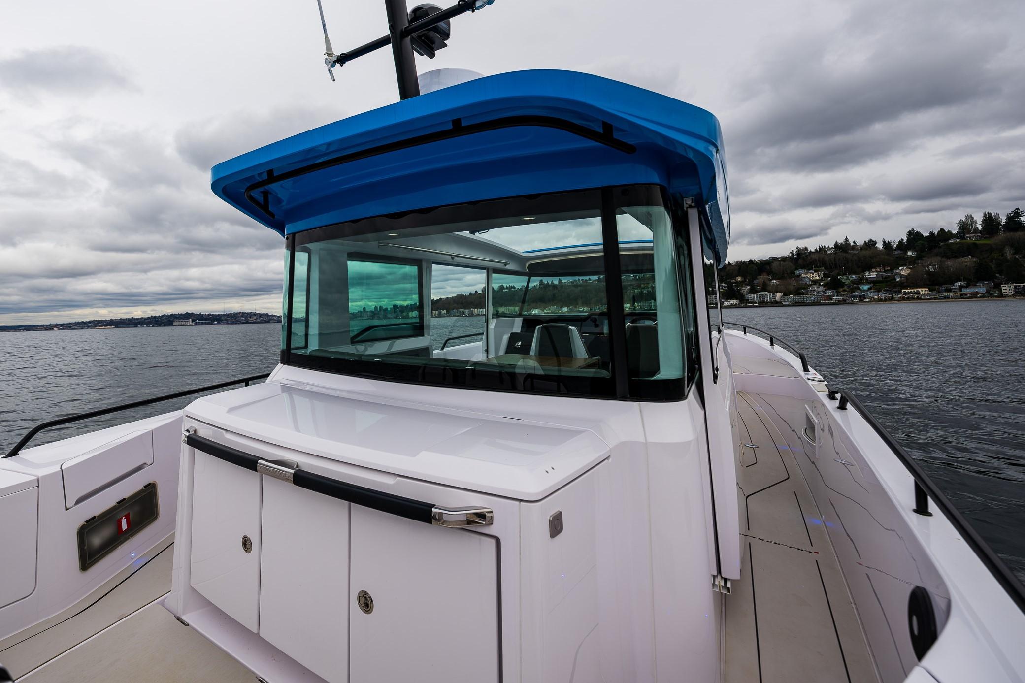 Axopar-37xc  Wetbar 2021-AQVAVIT WA-US-2021 Axopar 37xc Wetbar boat on a cloudy day, featuring sleek design and spacious deck.-9703795 | Thumbnail