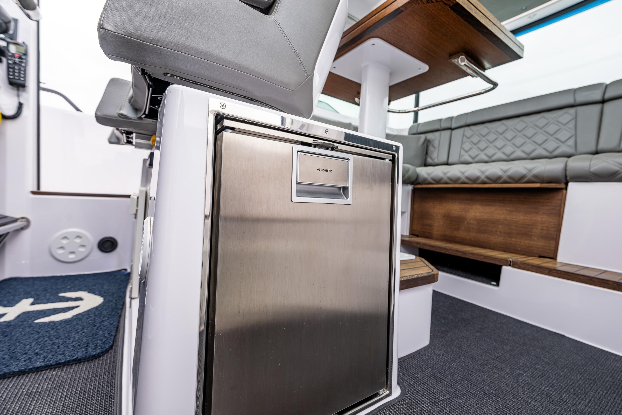 Axopar-37xc  Wetbar 2021-AQVAVIT WA-US-2021 Axopar 37xc Wetbar interior with seating and stainless steel fridge.-9703795 | Thumbnail