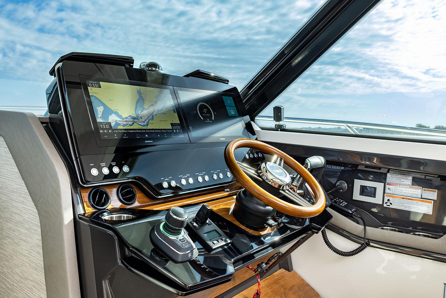 Manufacturer Provided Image: Helm of 2025 Tiara Yachts 43 LE with advanced navigation system and wooden steering wheel.