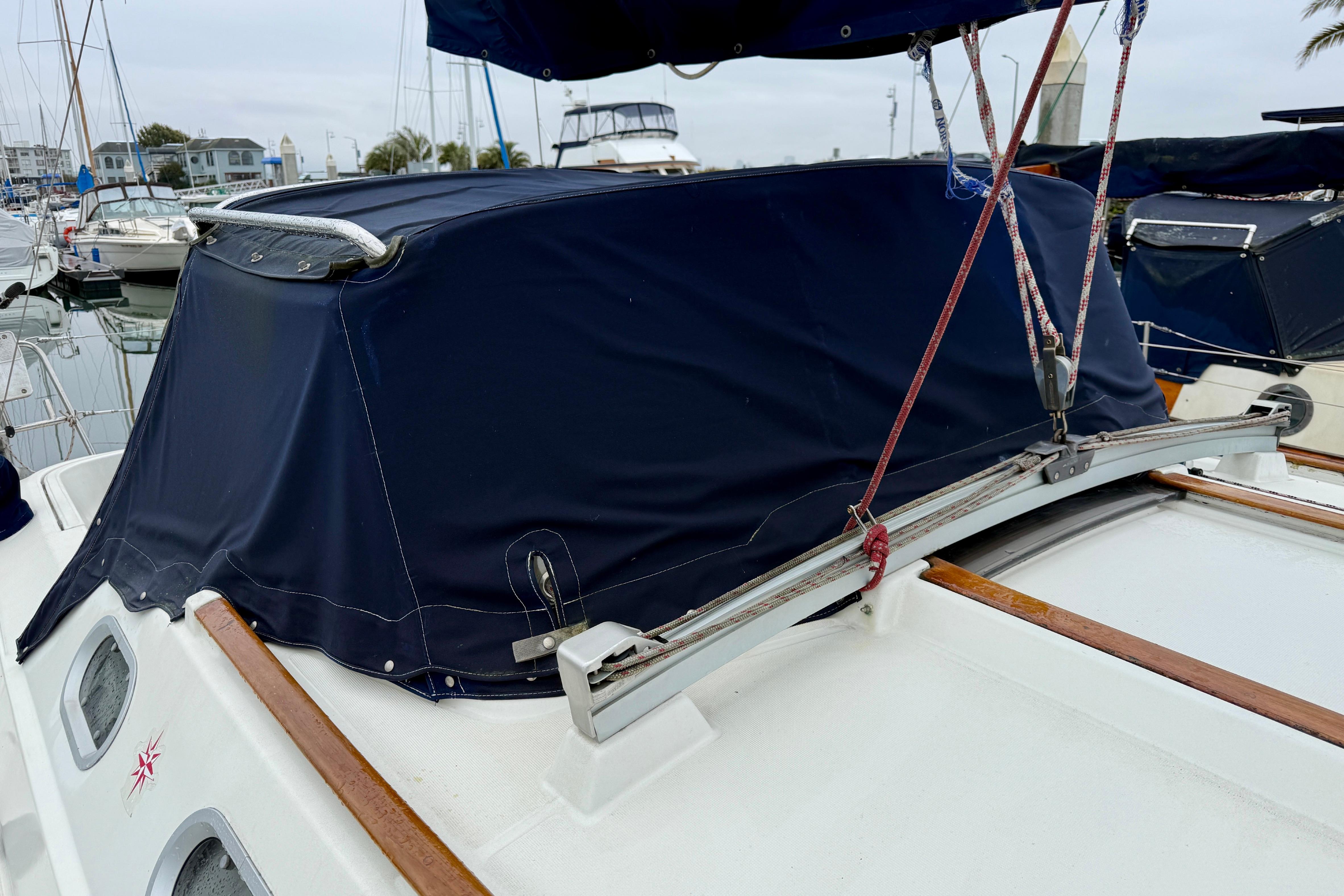 Jeanneau Sun Odyssey 36.2 sailboat, 1997 model, with blue canvas cover in marina.