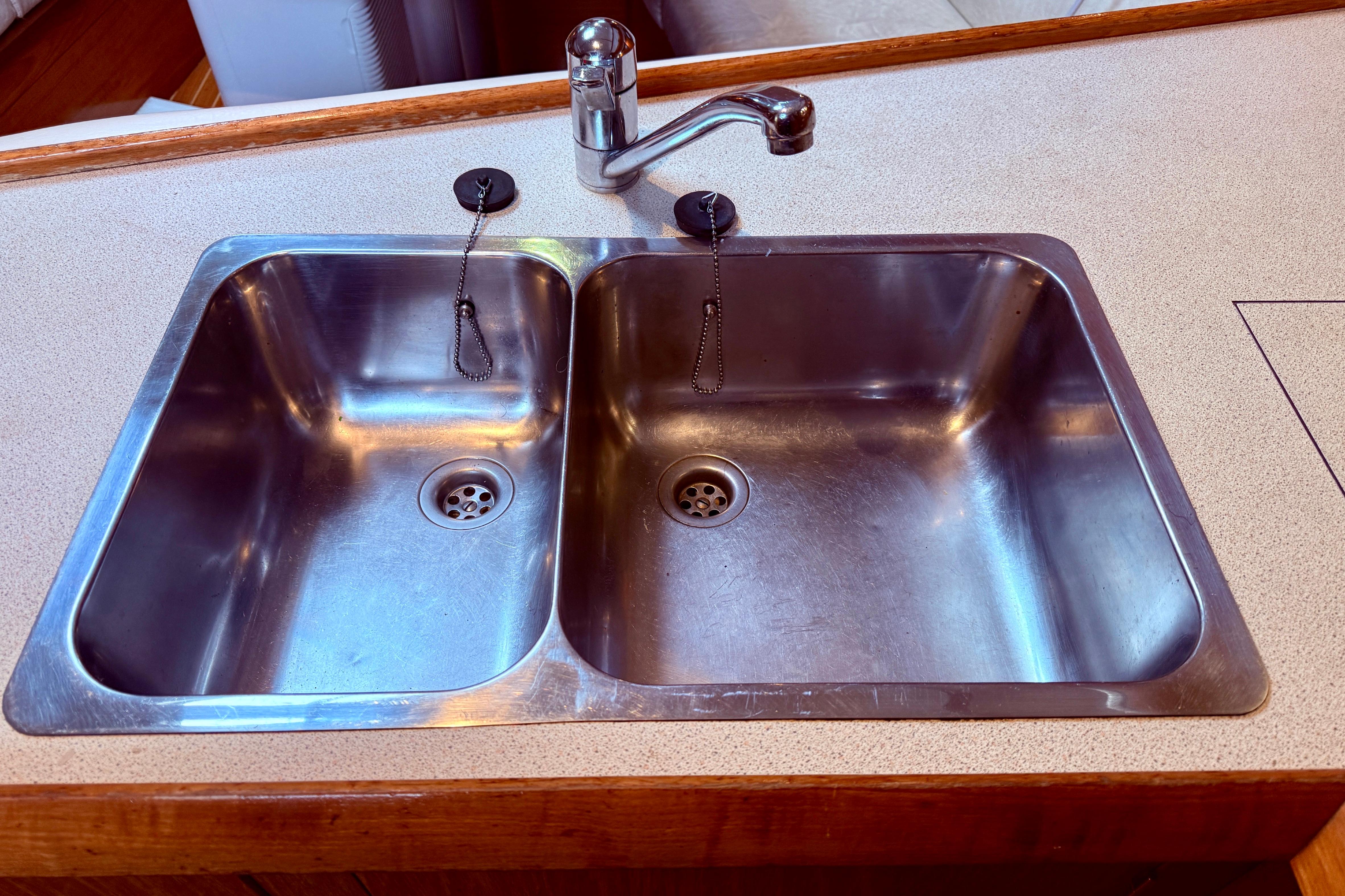 Stainless steel double sink in 1997 Jeanneau Sun Odyssey 36.2 yacht kitchen.