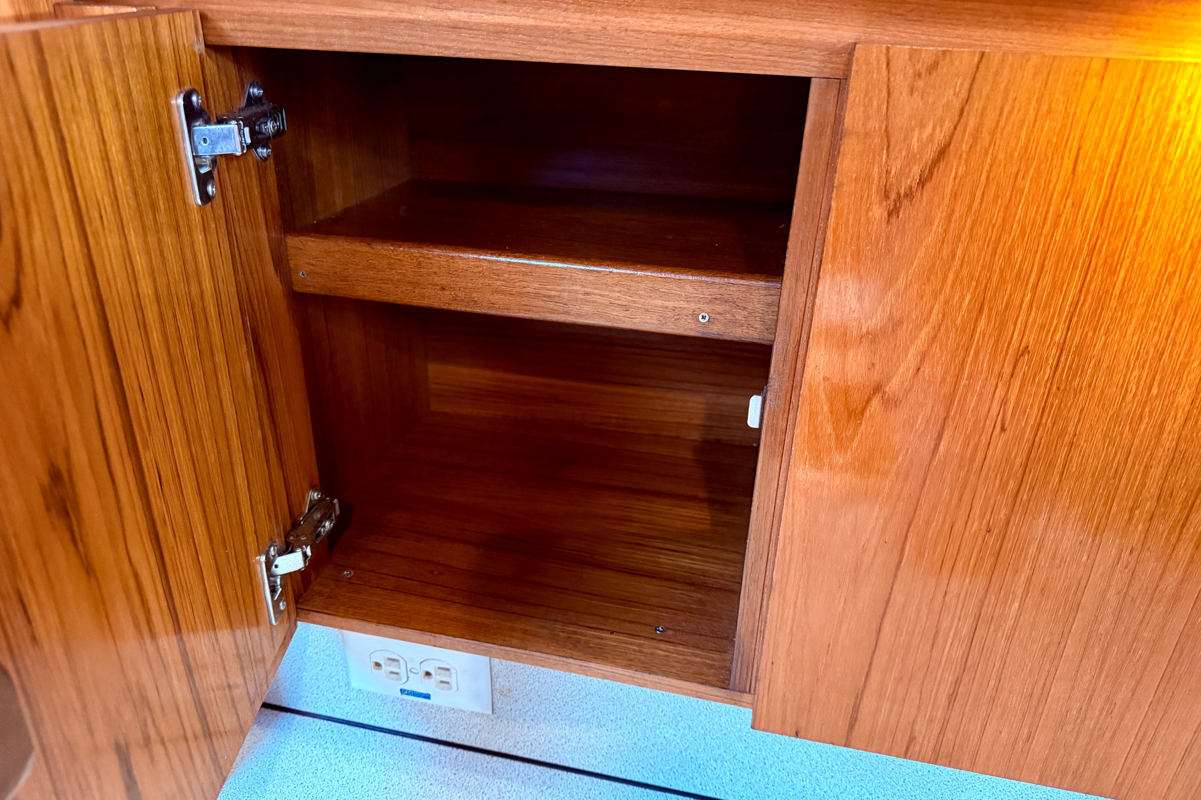Open wooden cabinet in Jeanneau Sun Odyssey 36.2 yacht, 1997 model.