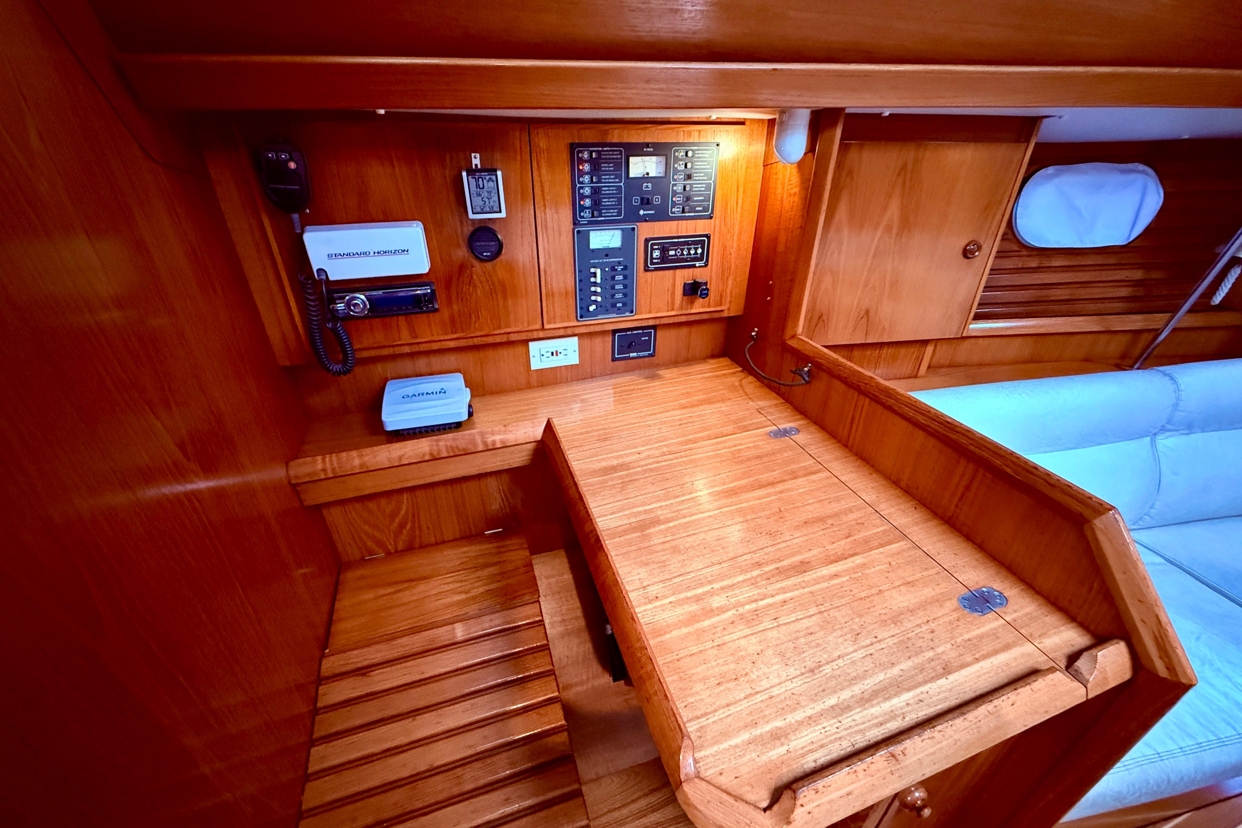 Navigation station of 1997 Jeanneau Sun Odyssey 36.2 with wooden finish and control panel.