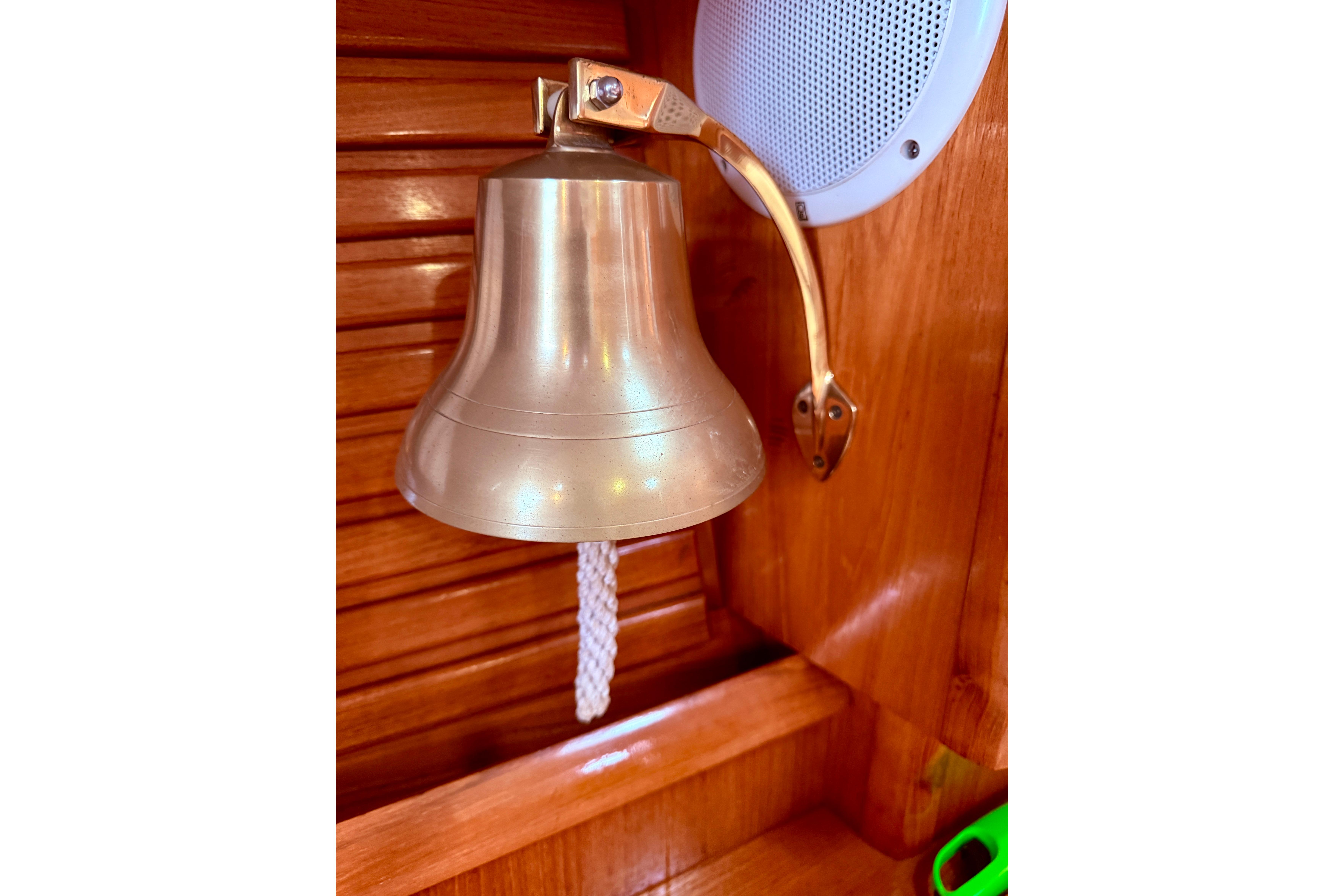 Brass bell on Jeanneau Sun Odyssey 36.2 yacht, 1997 model, with wooden interior.