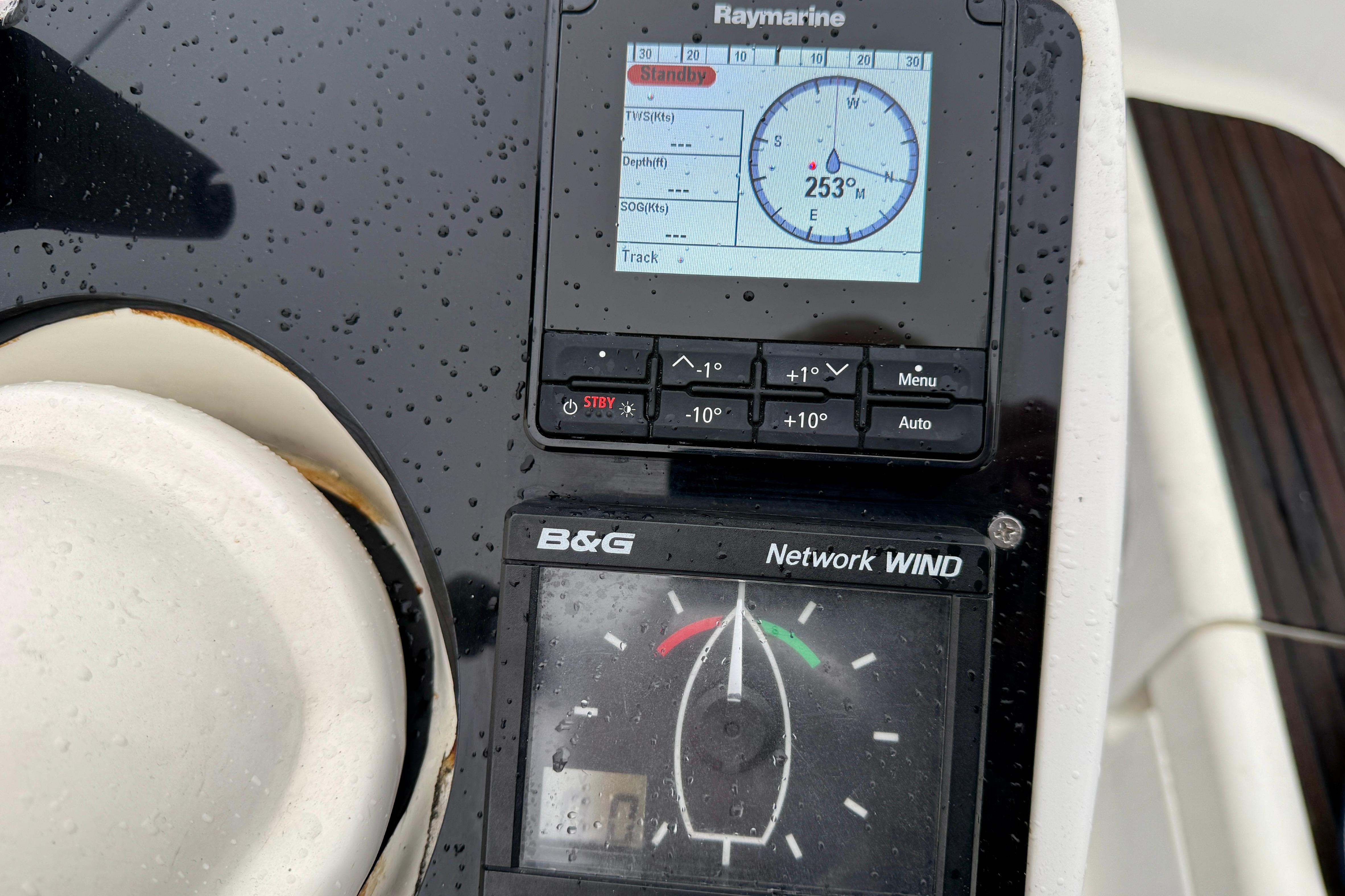 Rain-soaked navigation instruments on a 1997 Jeanneau Sun Odyssey 36.2 sailboat.