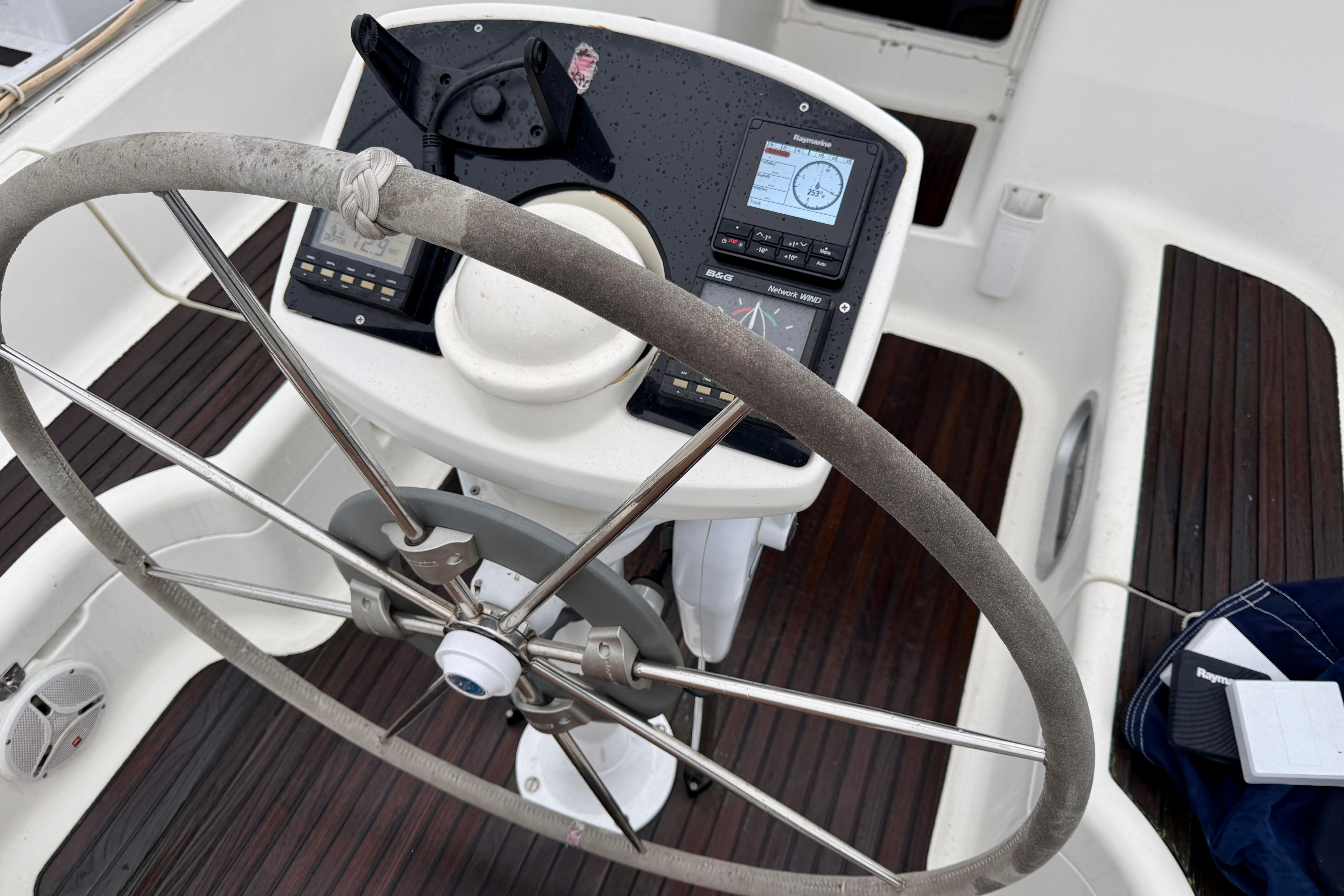 Steering wheel and navigation instruments on a 1997 Jeanneau Sun Odyssey 36.2 sailboat.