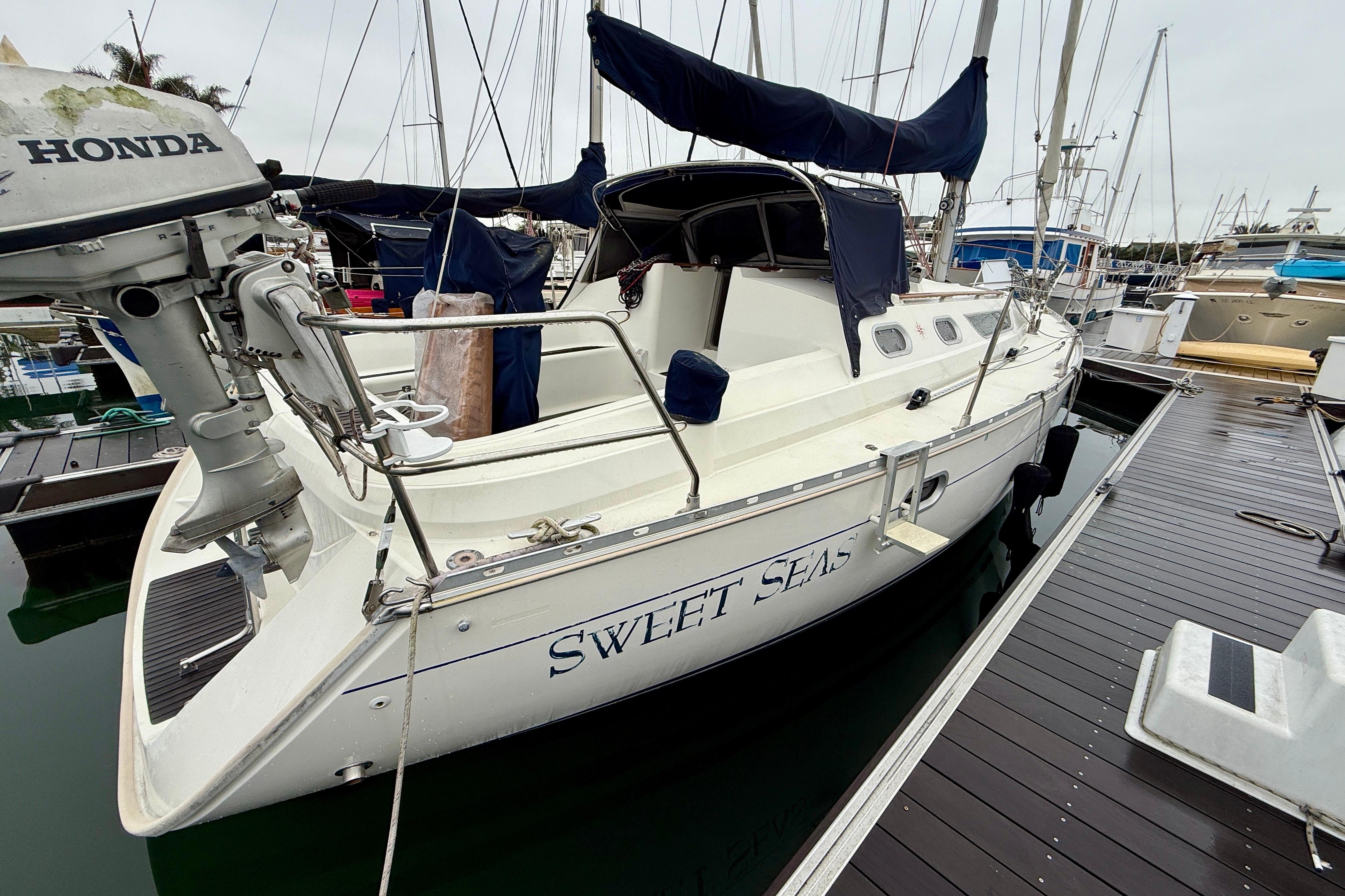 1997 Jeanneau Sun Odyssey 36.2 sailboat docked, featuring a Honda outboard motor.