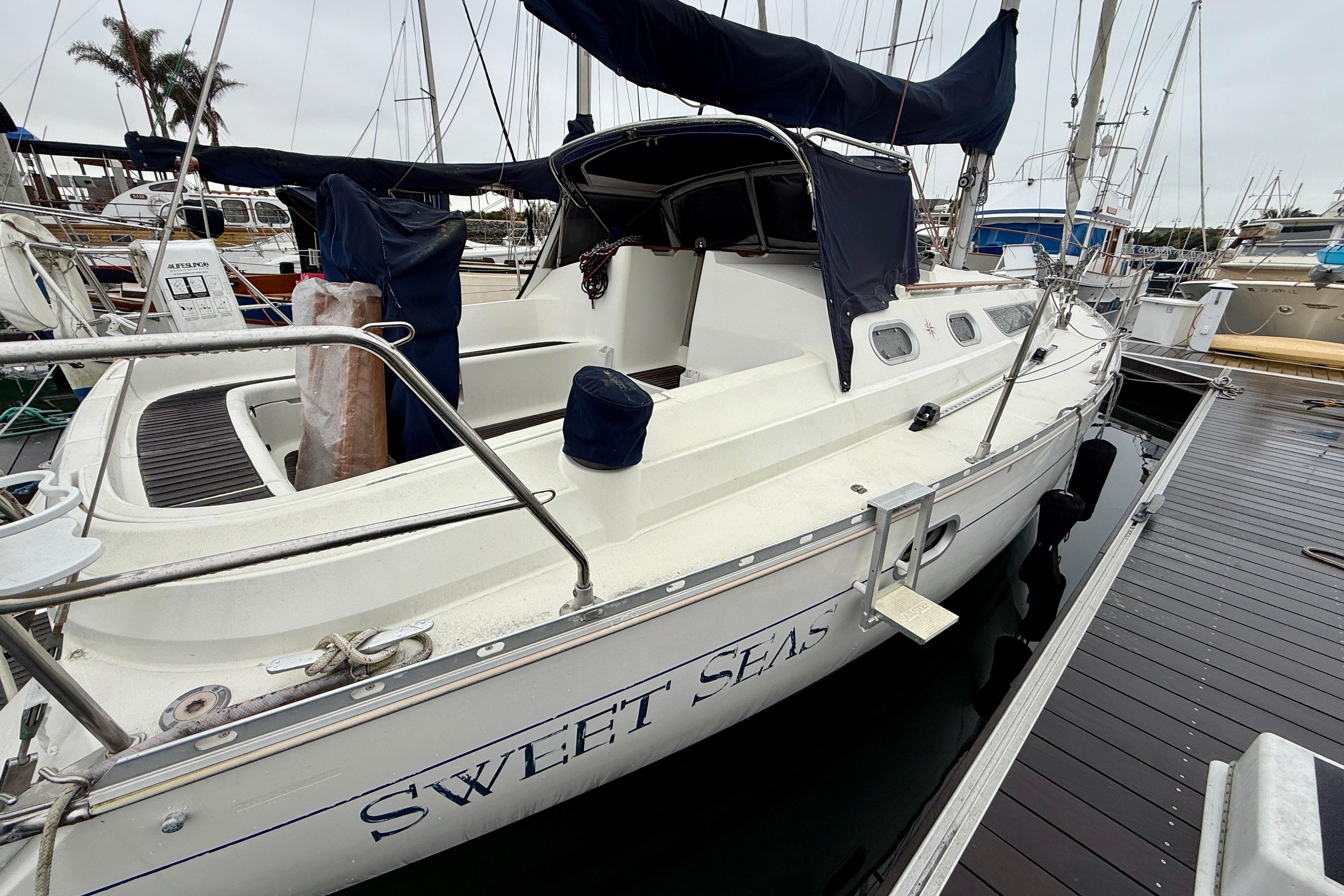1997 Jeanneau Sun Odyssey 36.2 sailboat docked, named "Sweet Seas," with covered cockpit.