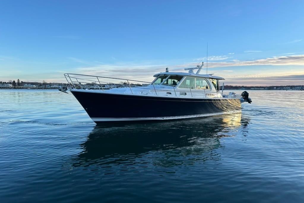 2020 Sabre 45 Salon Express yacht on calm water at sunset.
