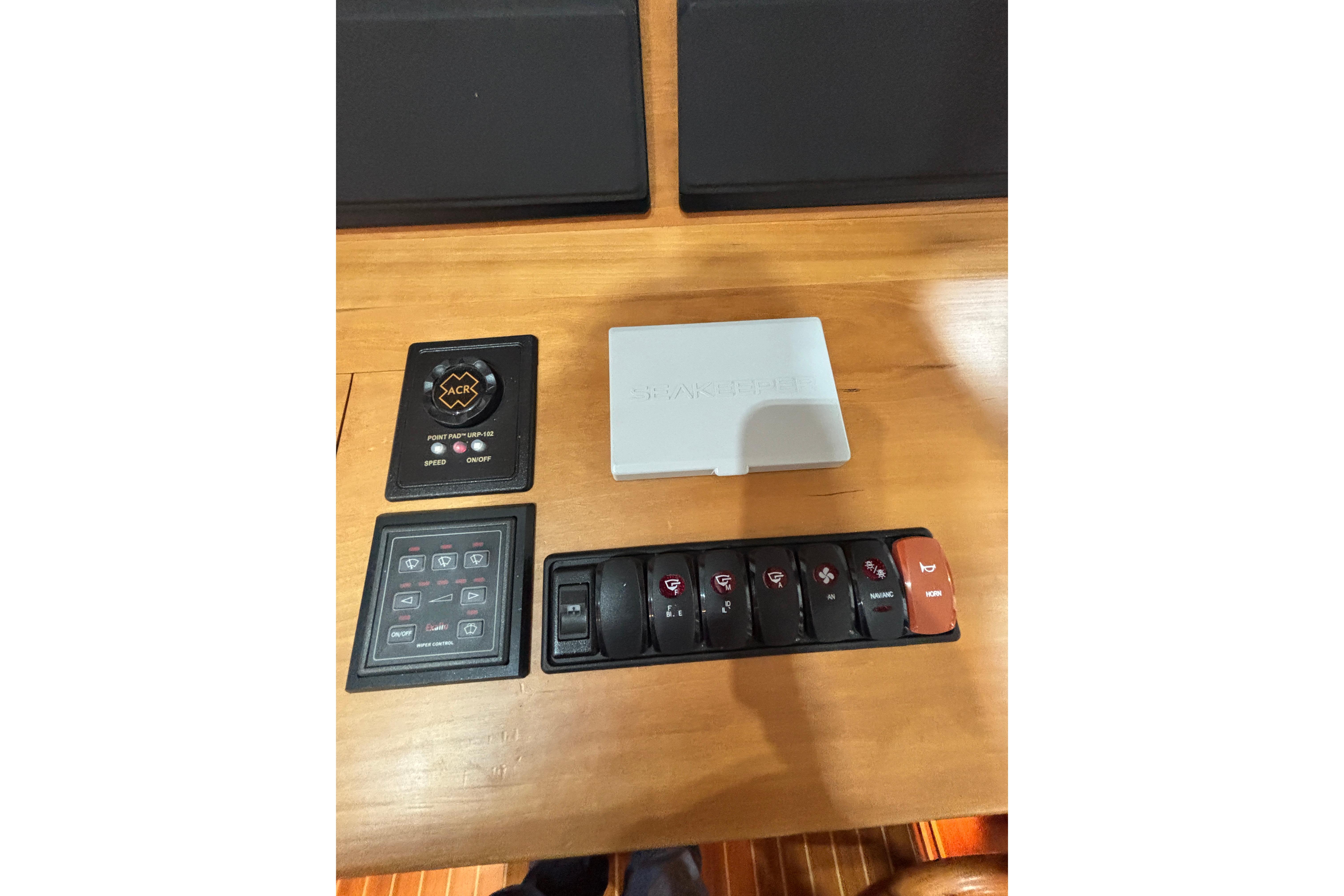 Control panel of a 2020 Sabre 45 Salon Express yacht with various switches and buttons.