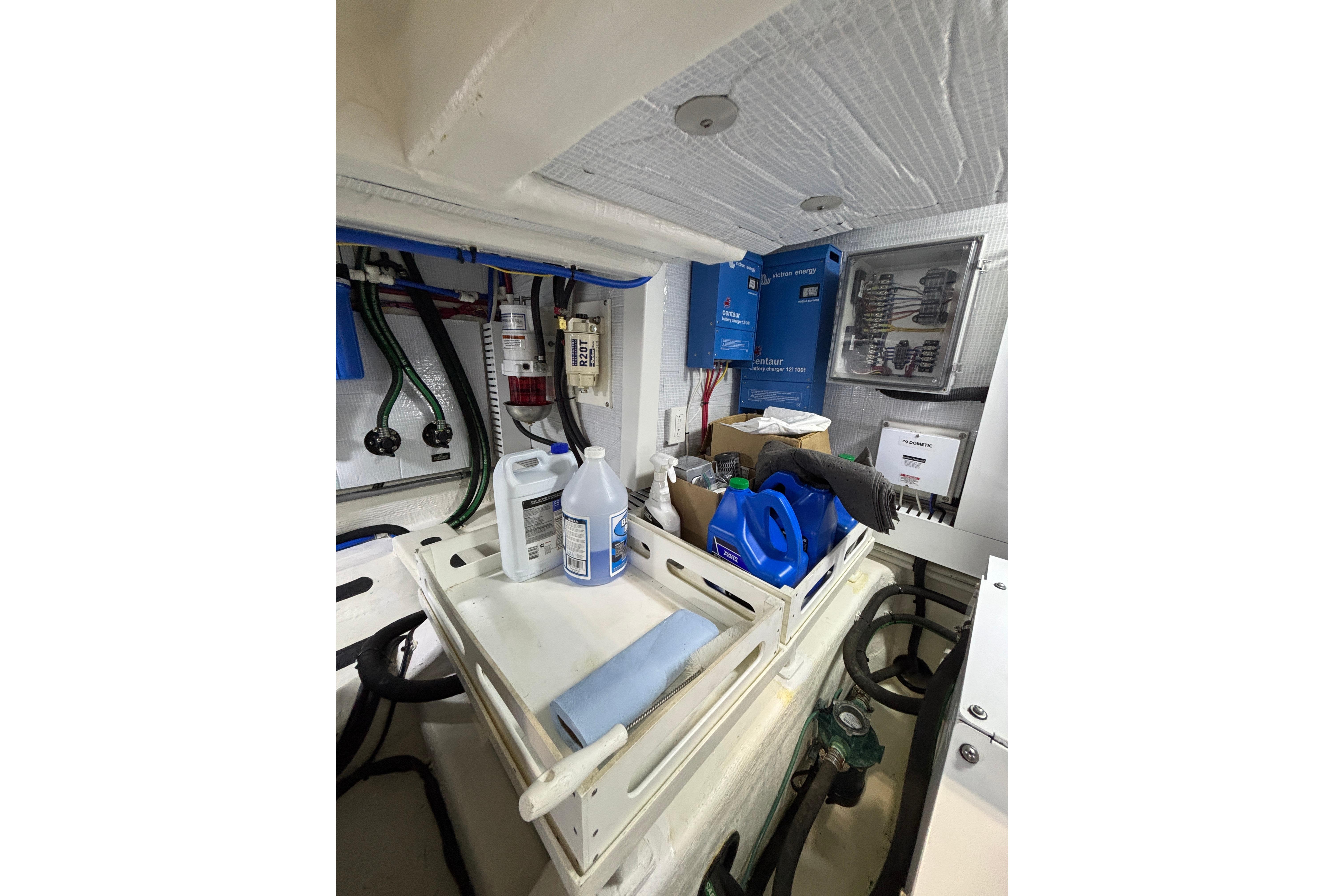 Engine room of 2020 Sabre 45 Salon Express with maintenance supplies and equipment.
