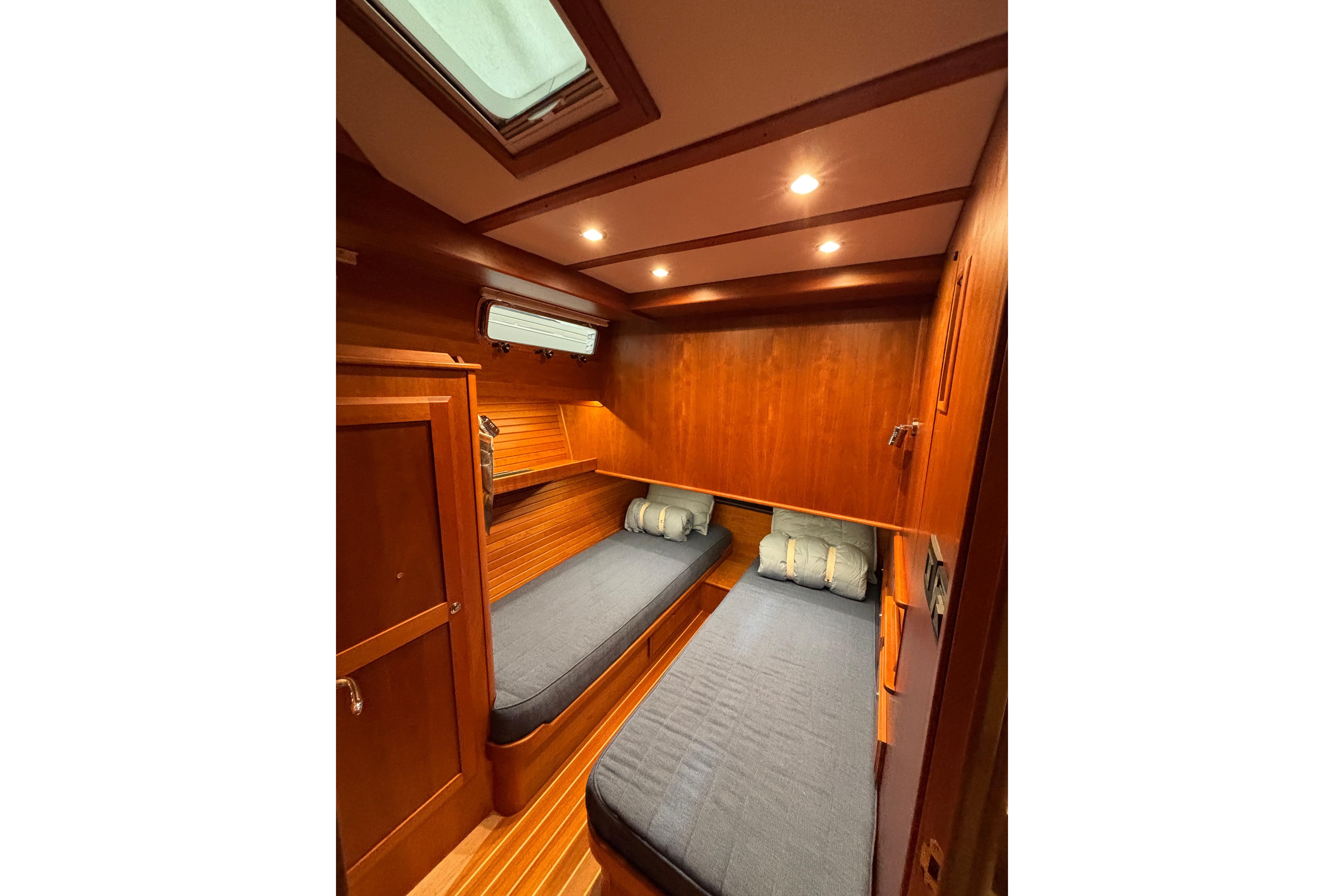 2020 Sabre 45 Salon Express cabin with twin beds, wooden interior, and overhead lighting.