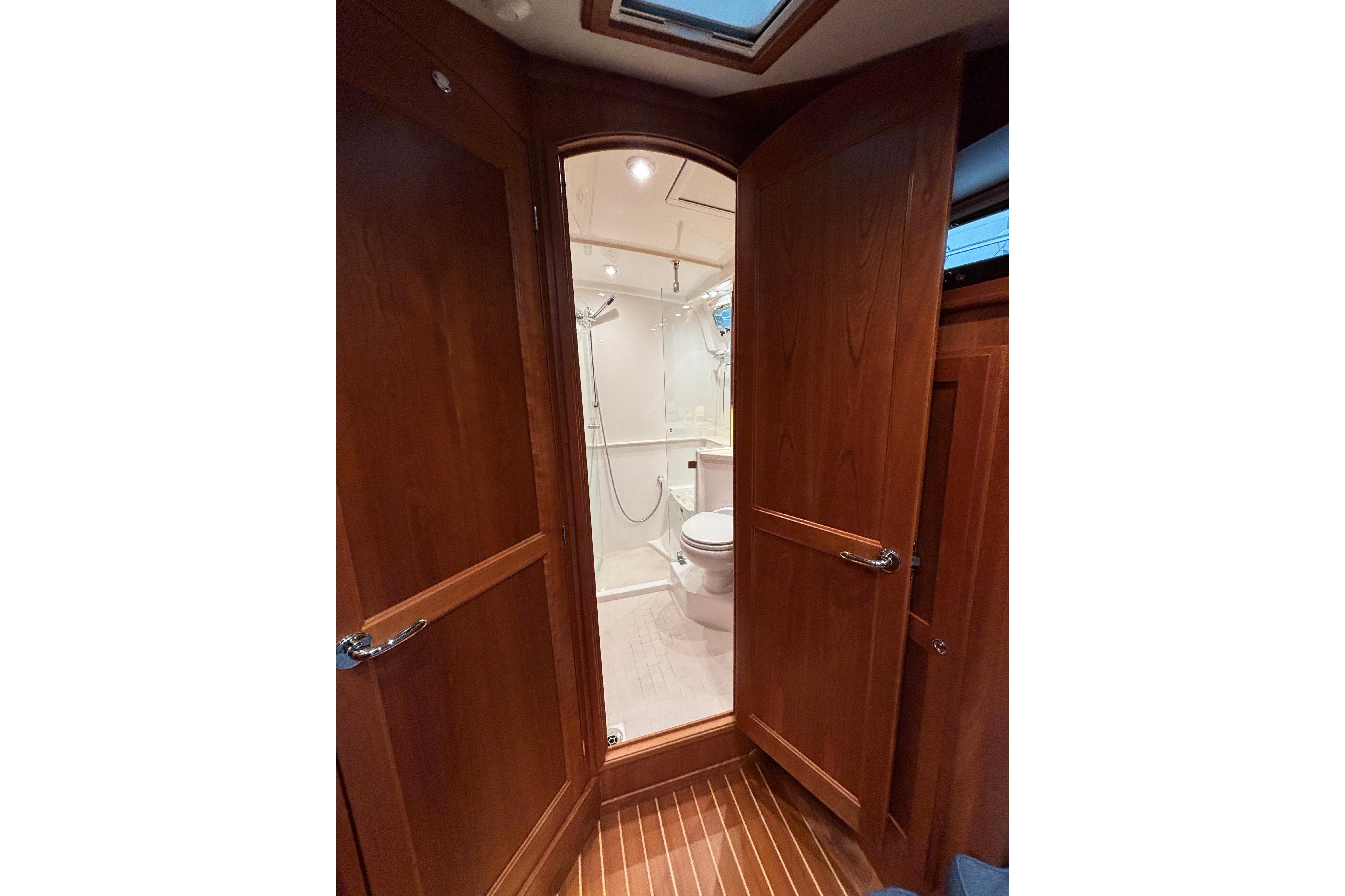 2020 Sabre 45 Salon Express bathroom with wooden doors and modern fixtures.