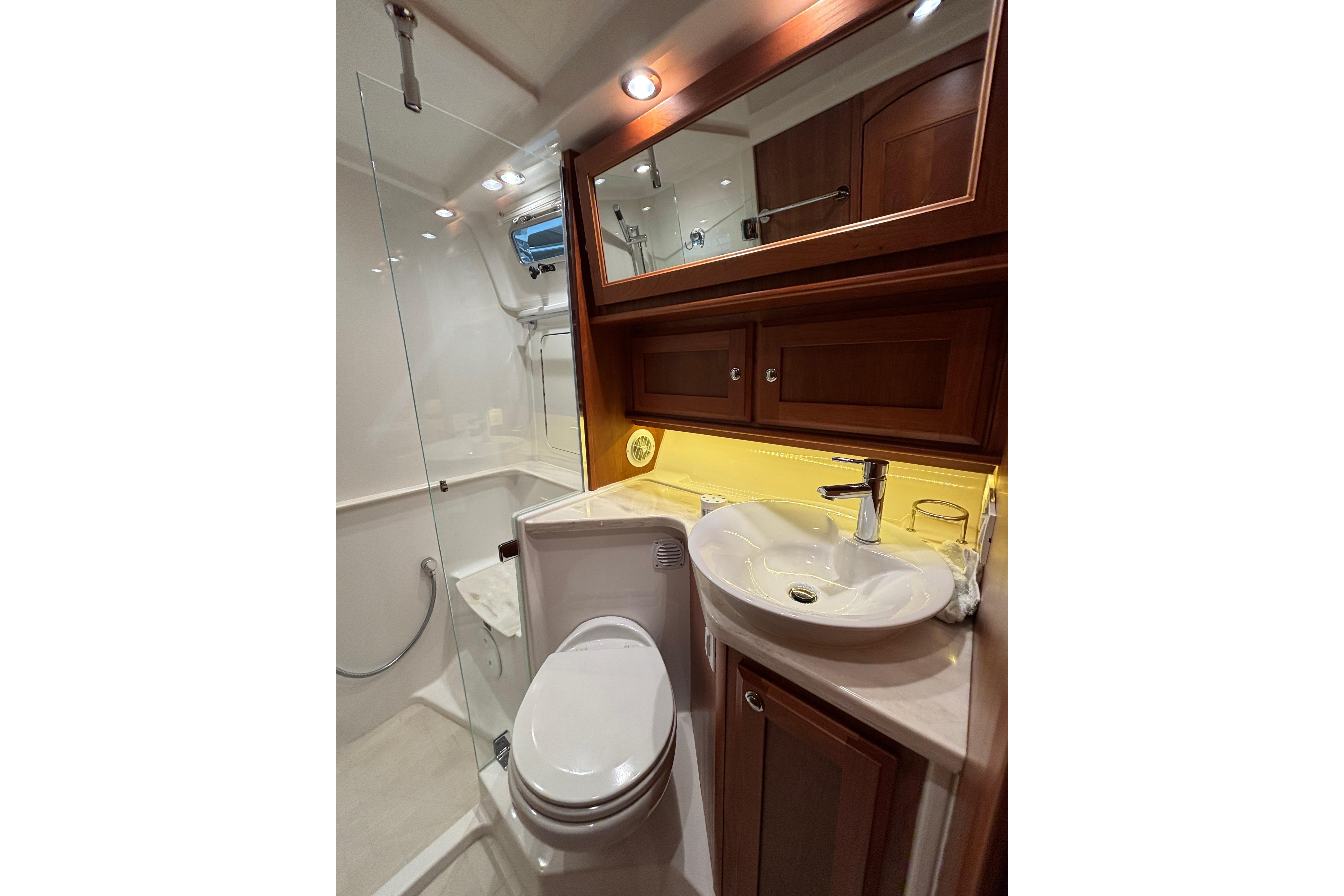 Luxurious bathroom in 2020 Sabre 45 Salon Express yacht with modern fixtures and wood cabinetry.