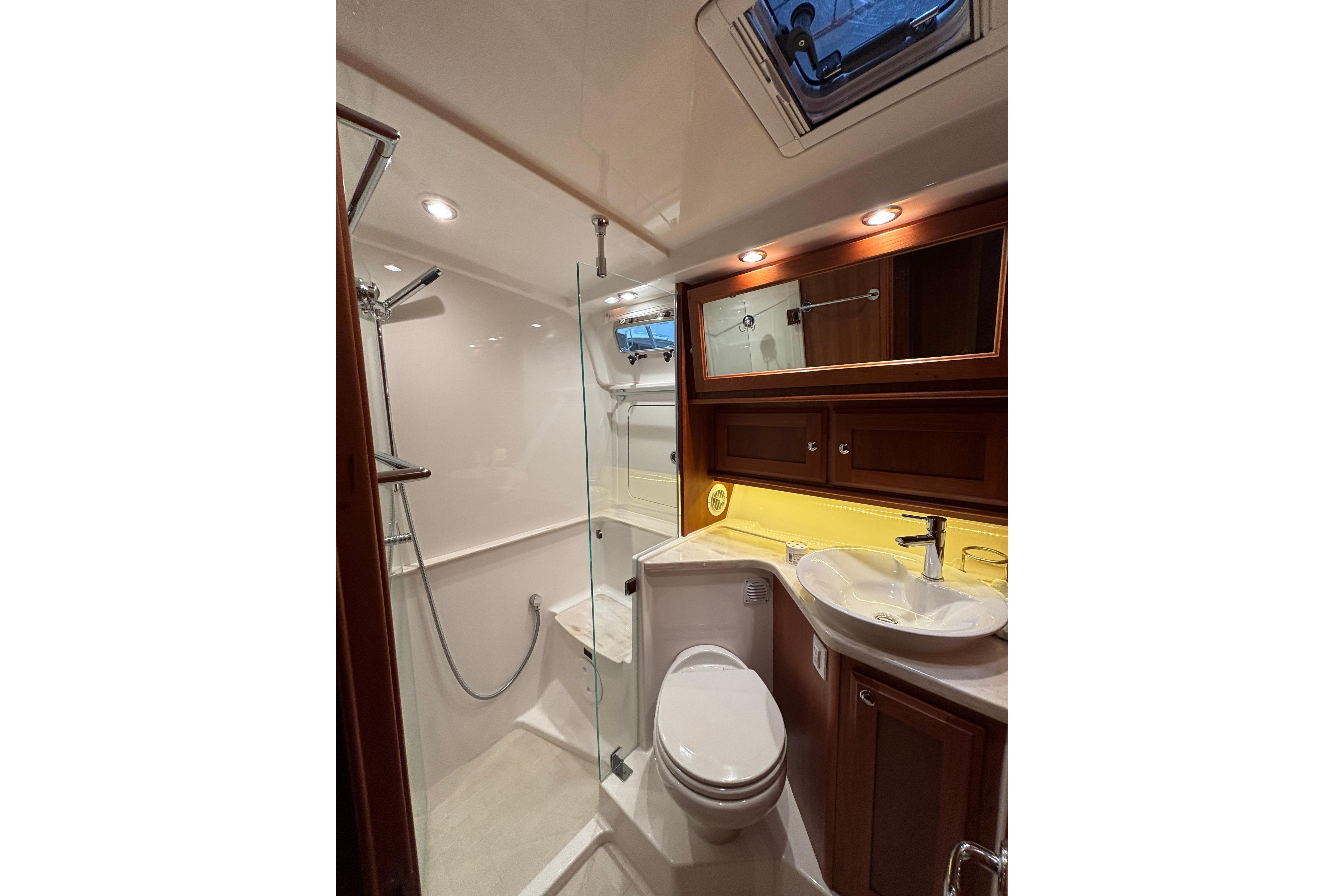 Luxurious bathroom in 2020 Sabre 45 Salon Express yacht with modern fixtures and wood accents.