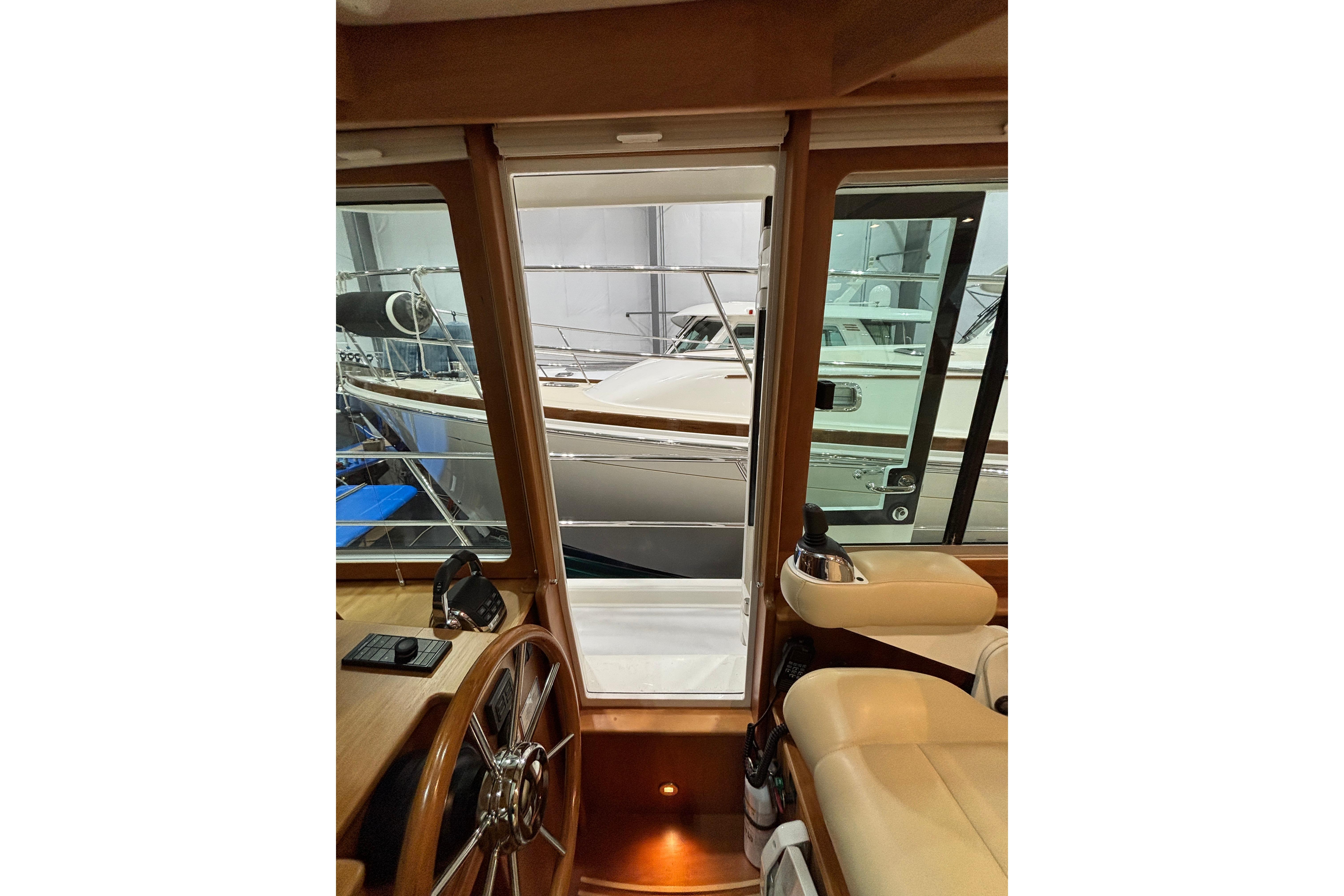 Interior view of 2020 Sabre 45 Salon Express yacht, showcasing helm and seating area.