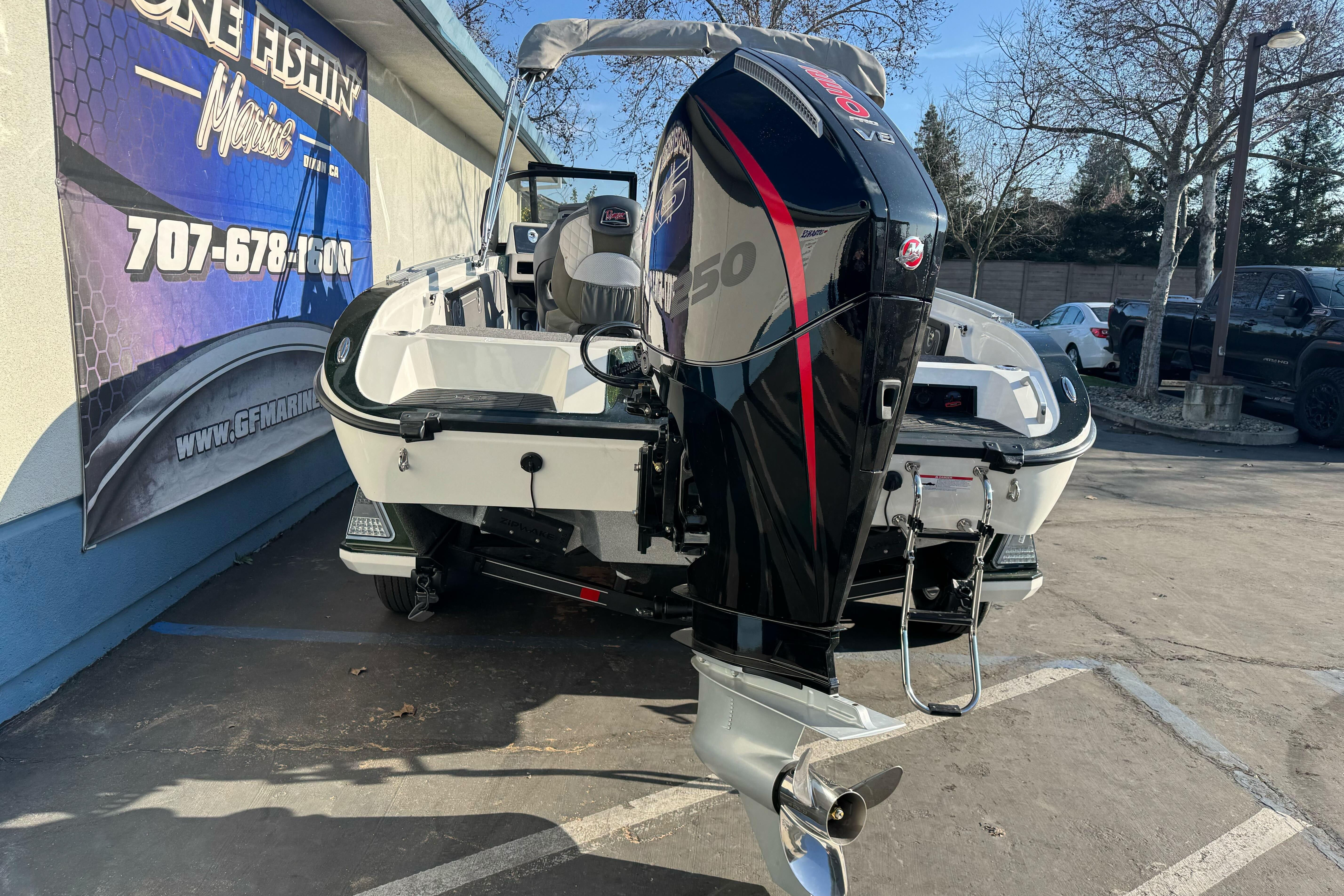 2026 Ranger 620xFS Pro boat with powerful outboard motor in parking lot.