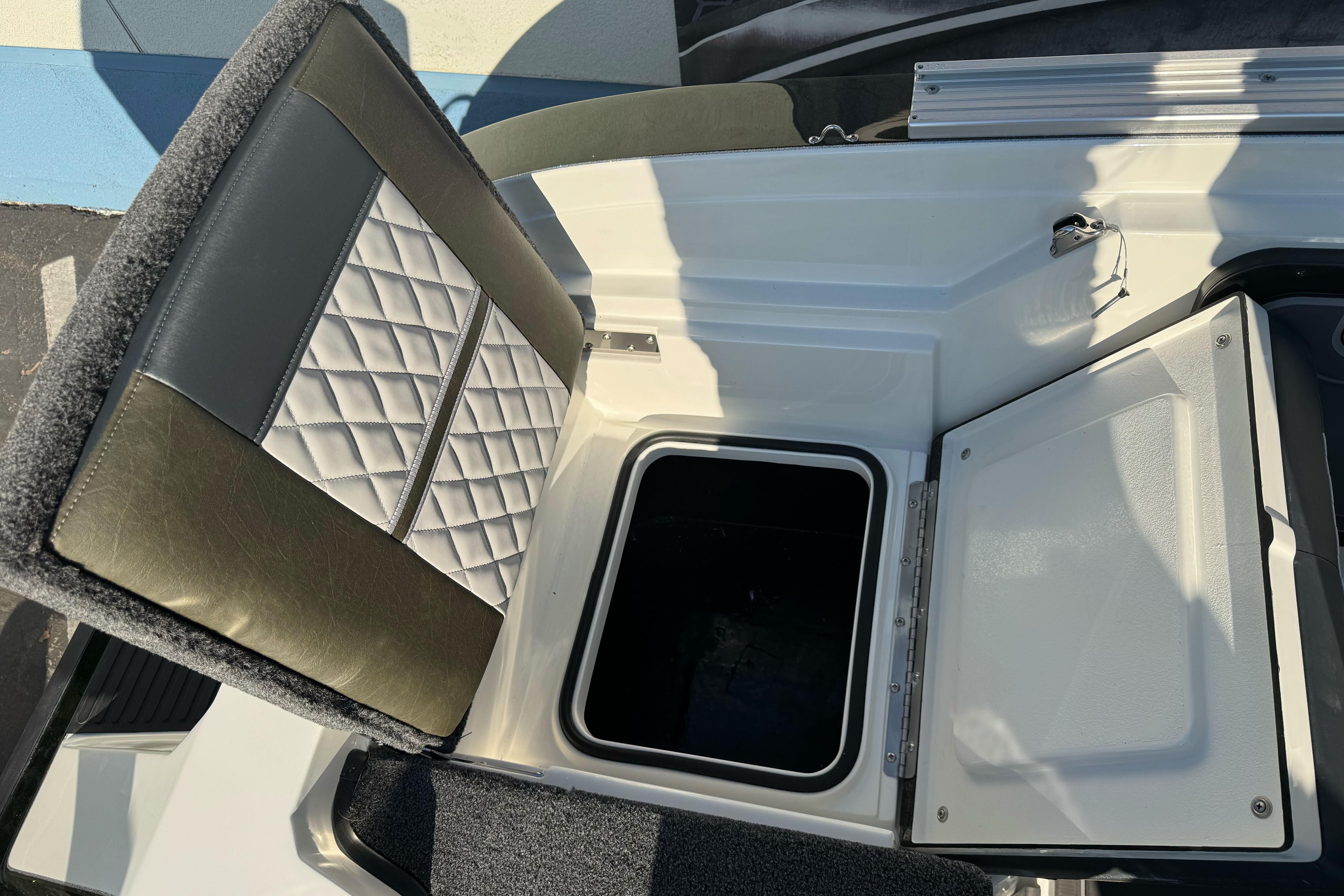 2026 Ranger 620xFS Pro boat seat with storage compartment open.