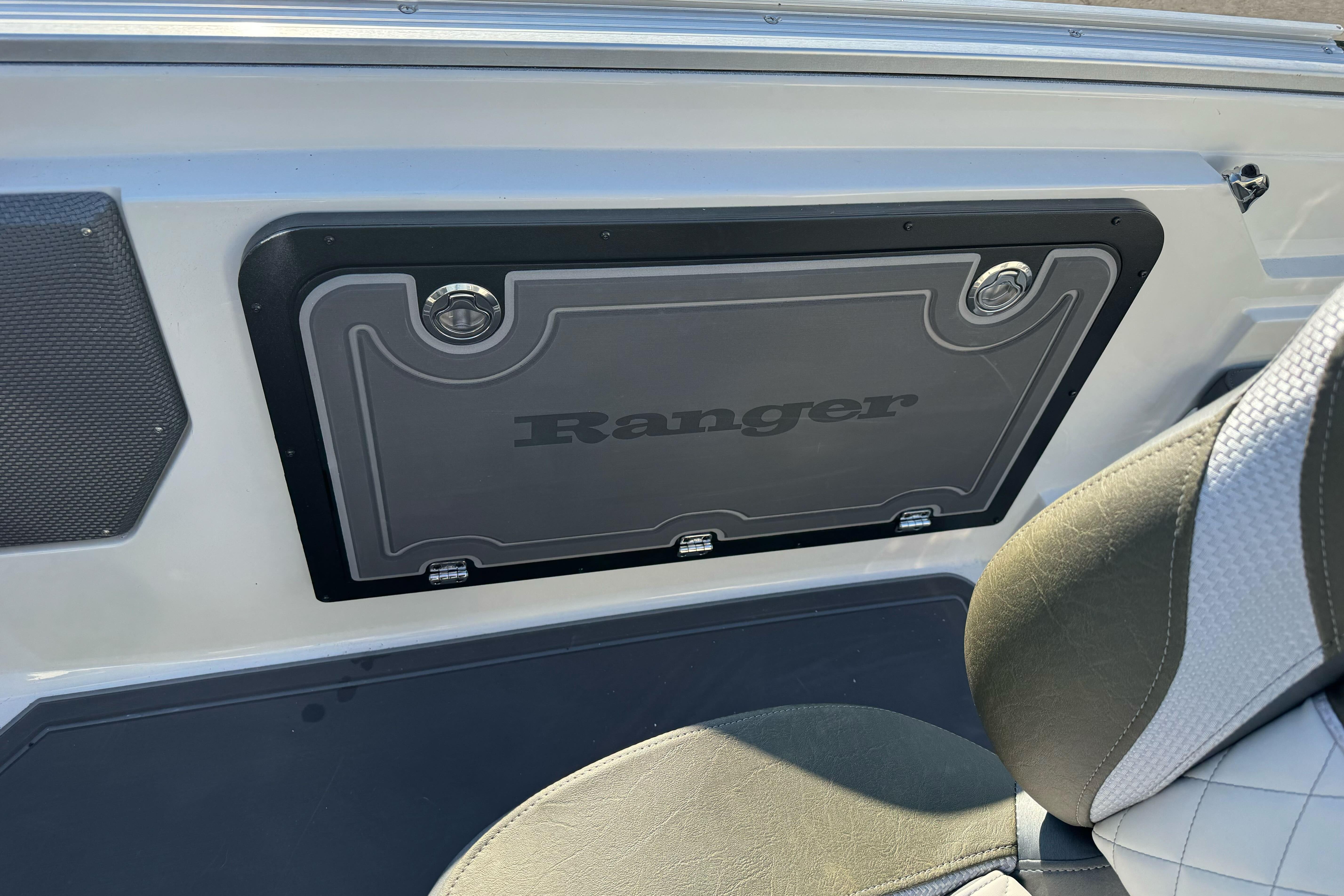 2026 Ranger 620xFS Pro boat interior with branded storage compartment and seating.