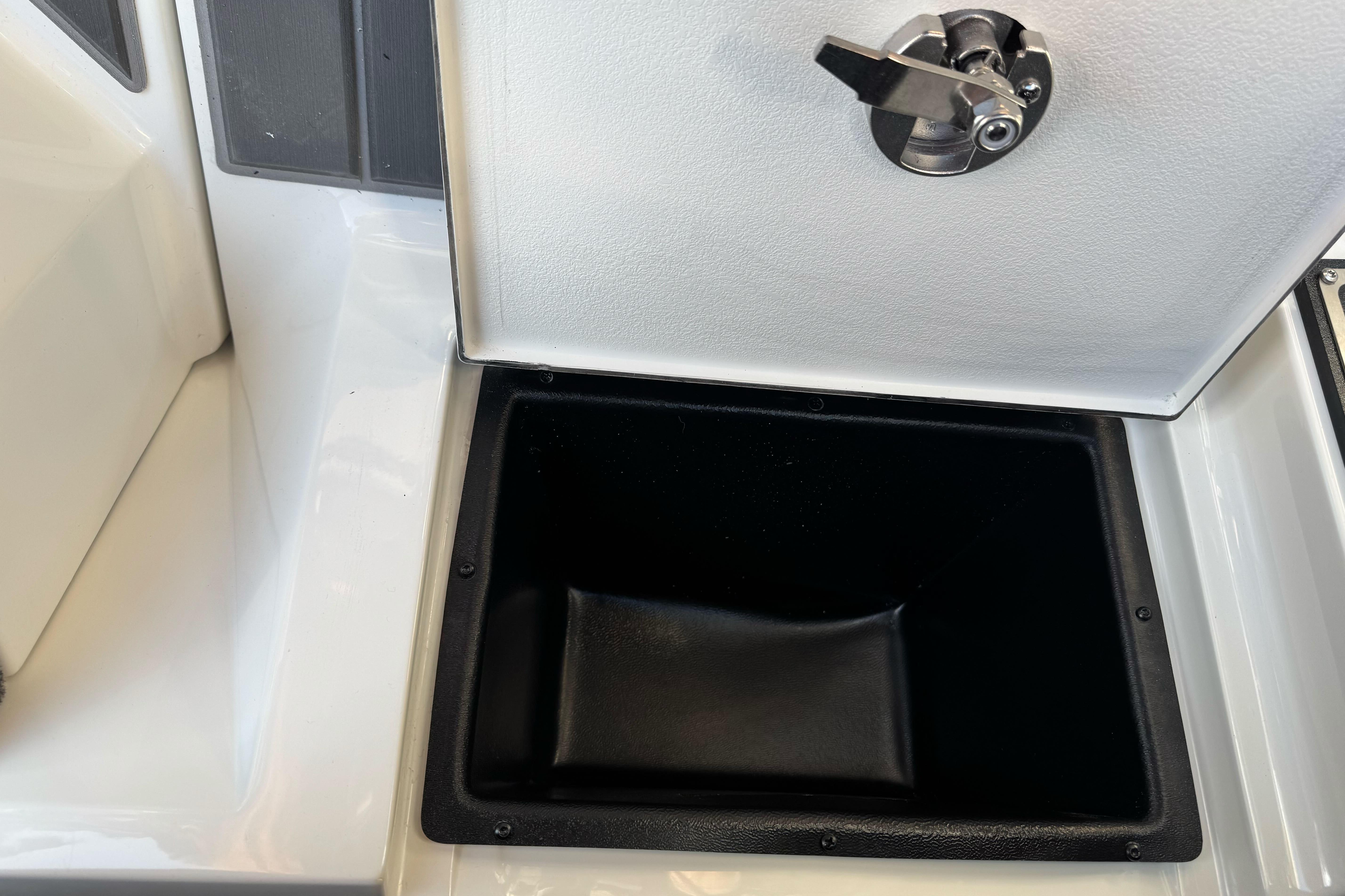 Open storage compartment in 2026 Ranger 620xFS Pro boat, featuring a secure latch.