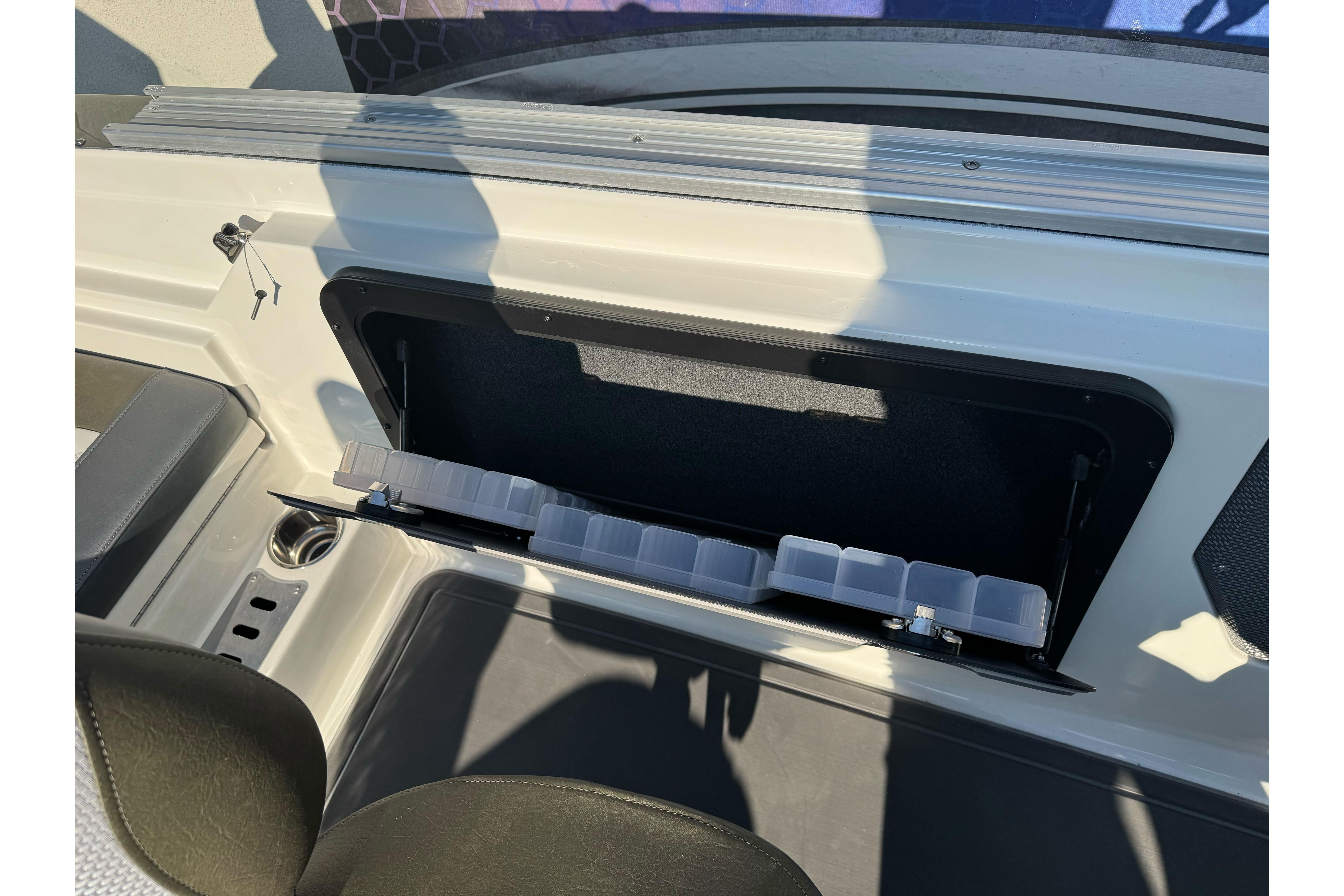 2026 Ranger 620xFS Pro boat storage compartment with organized tackle boxes.