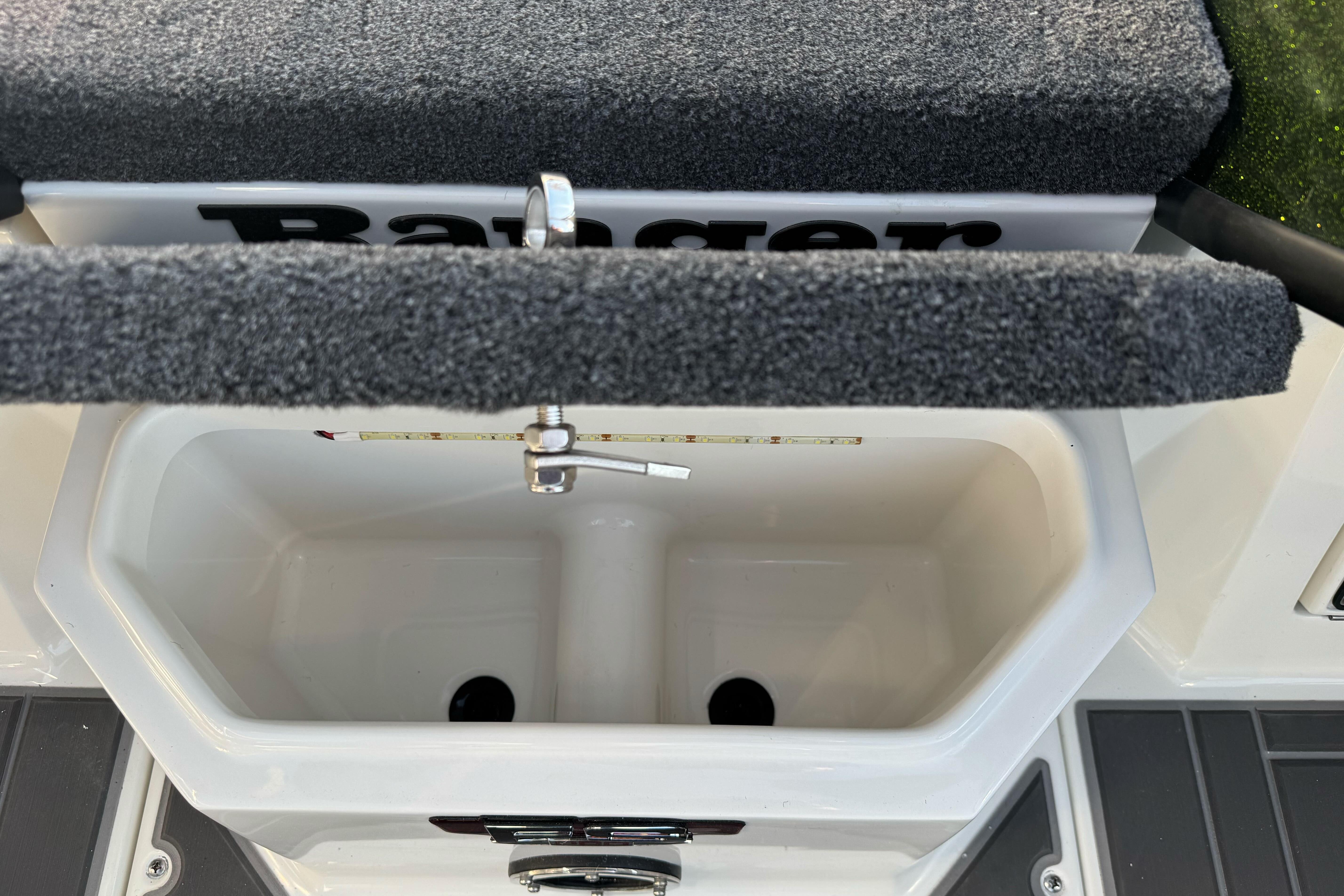 2026 Ranger 620xFS Pro boat livewell with carpeted lid and measuring ruler.