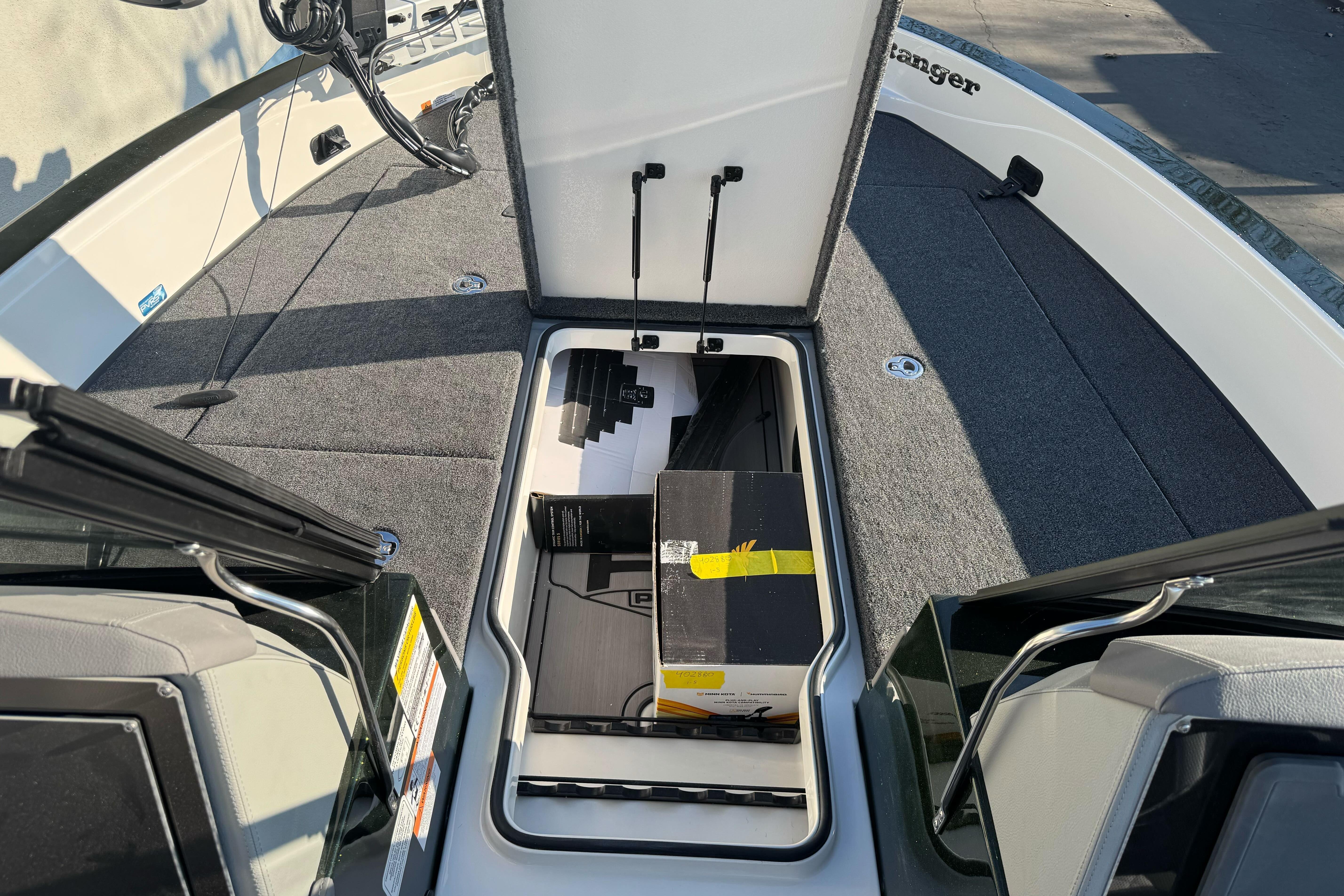 Open storage compartment on 2026 Ranger 620xFS Pro boat deck.