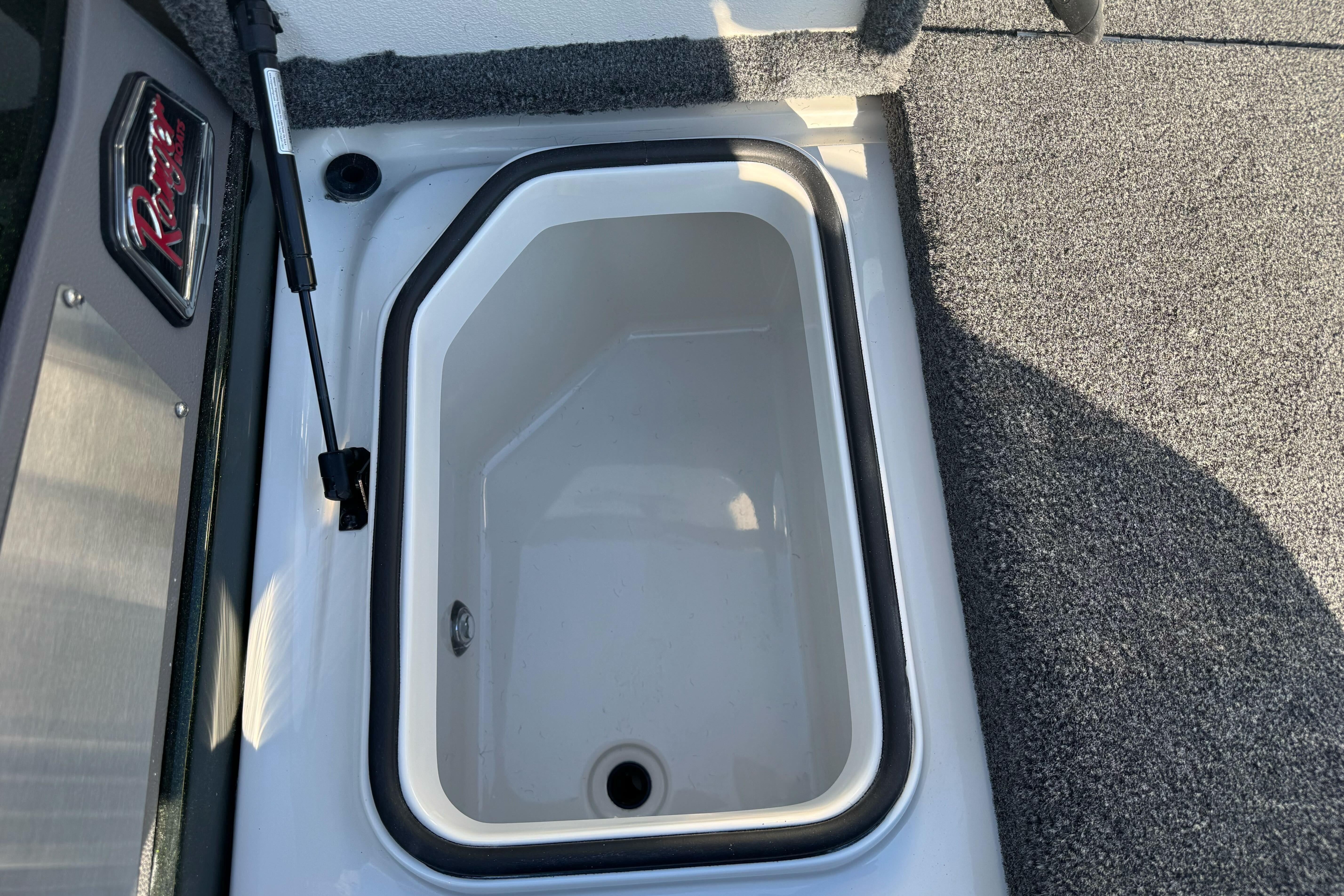 2026 Ranger 620xFS Pro boat storage compartment with carpeted interior.