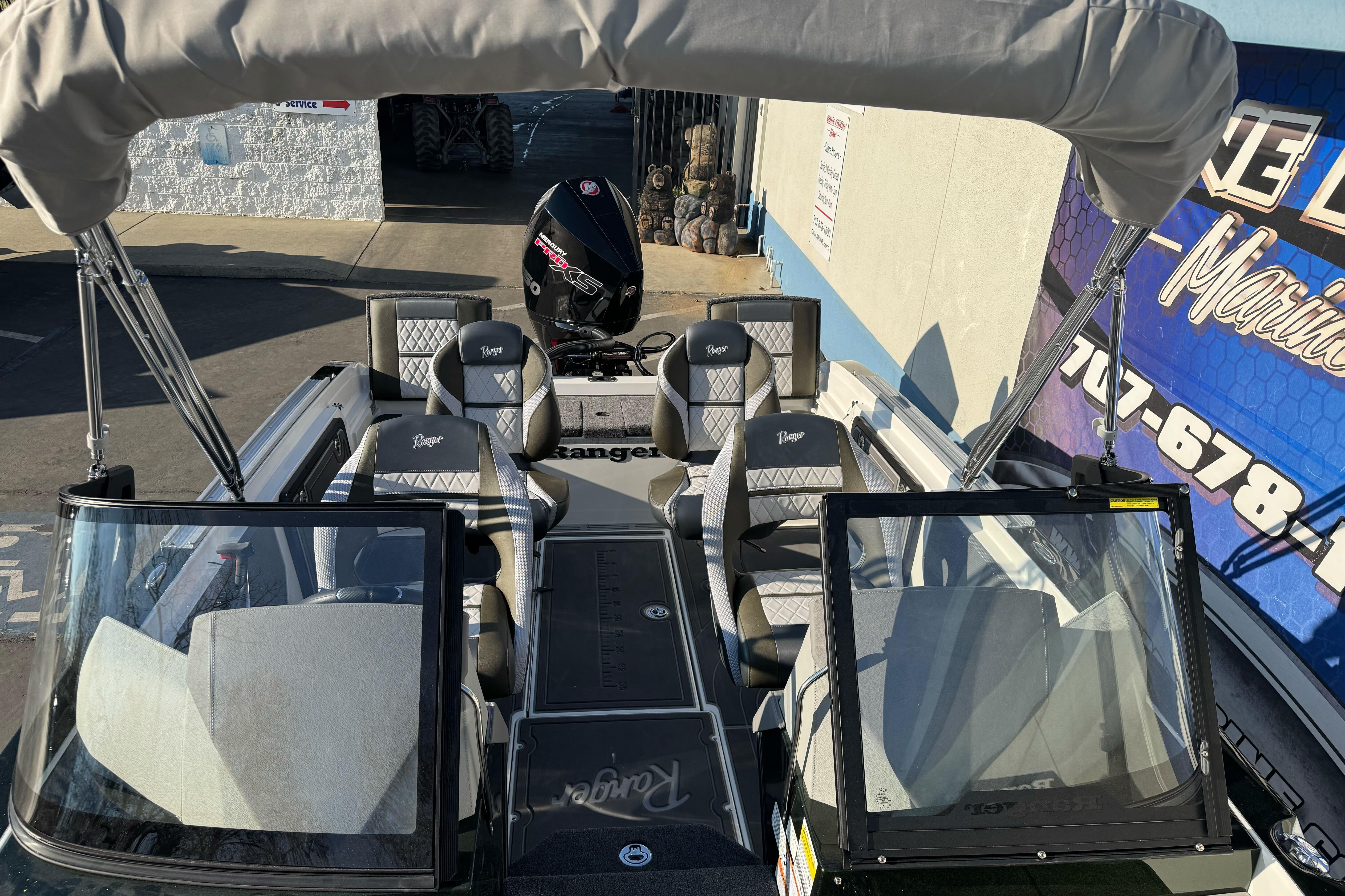 2026 Ranger 620xFS Pro boat with seating and canopy, displayed outdoors.