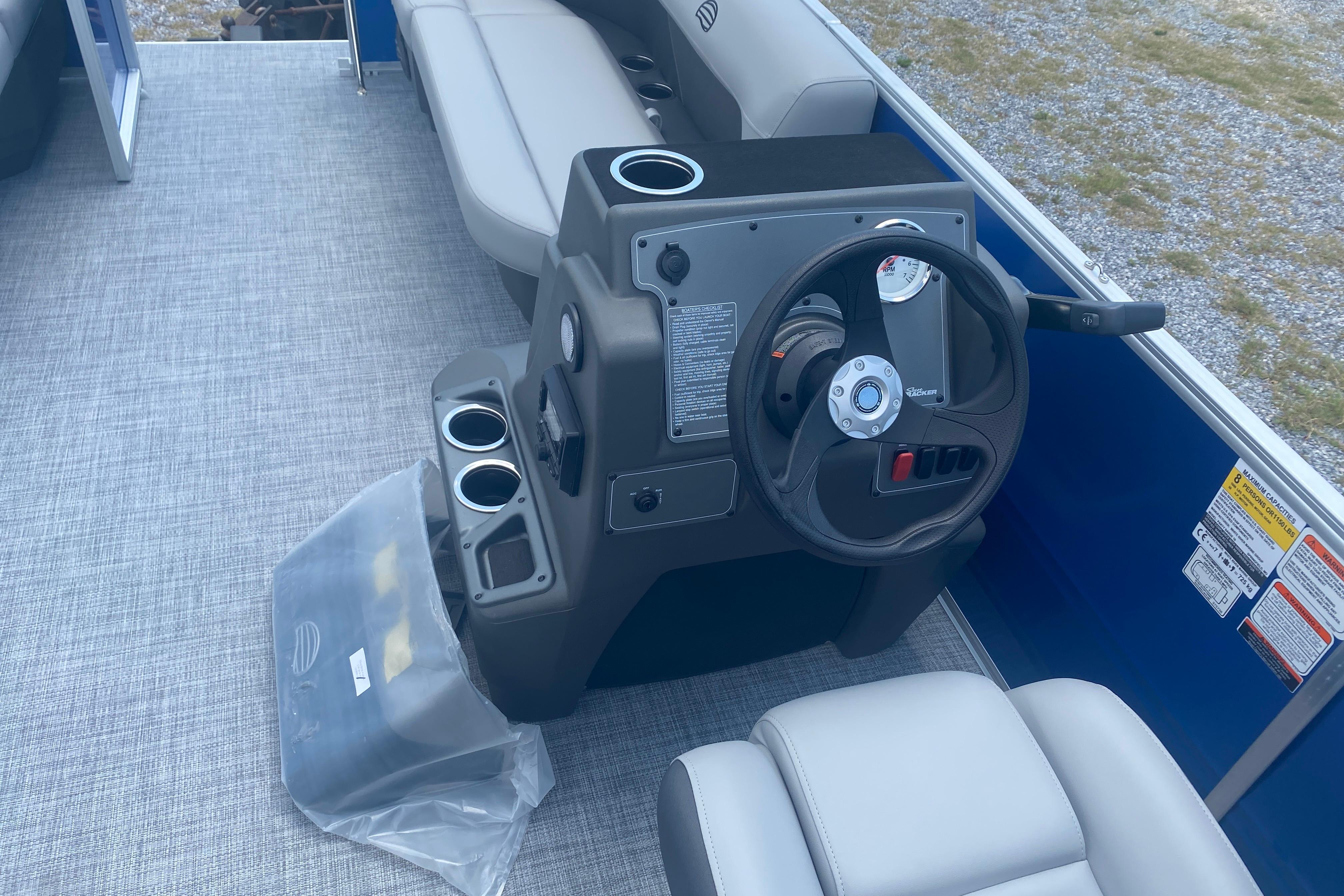 2026 Sun Tracker Party Barge 16 DLX interior with steering console and seating.