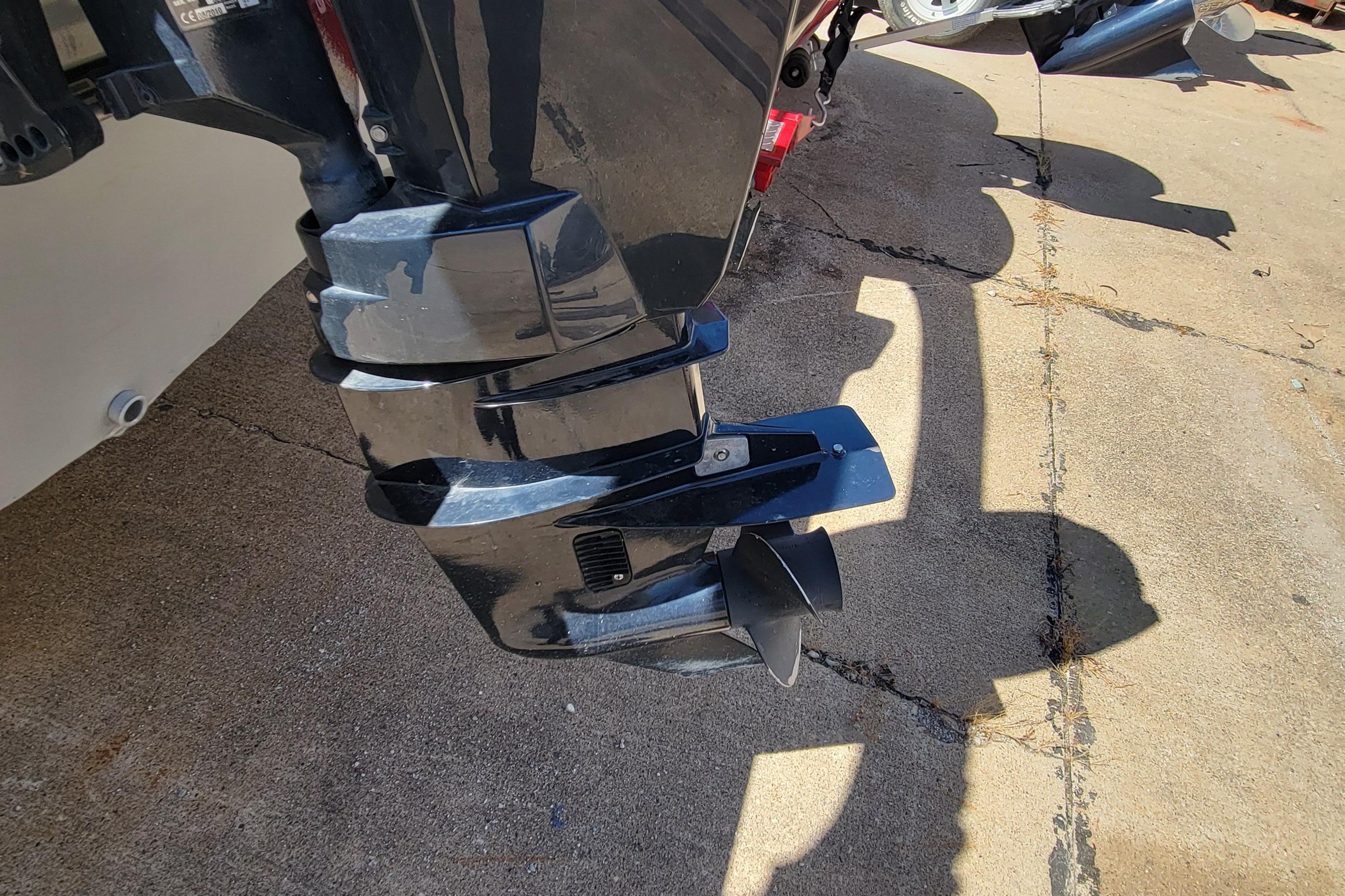 2010 Tracker Guide V 15 Laker boat motor on concrete surface.