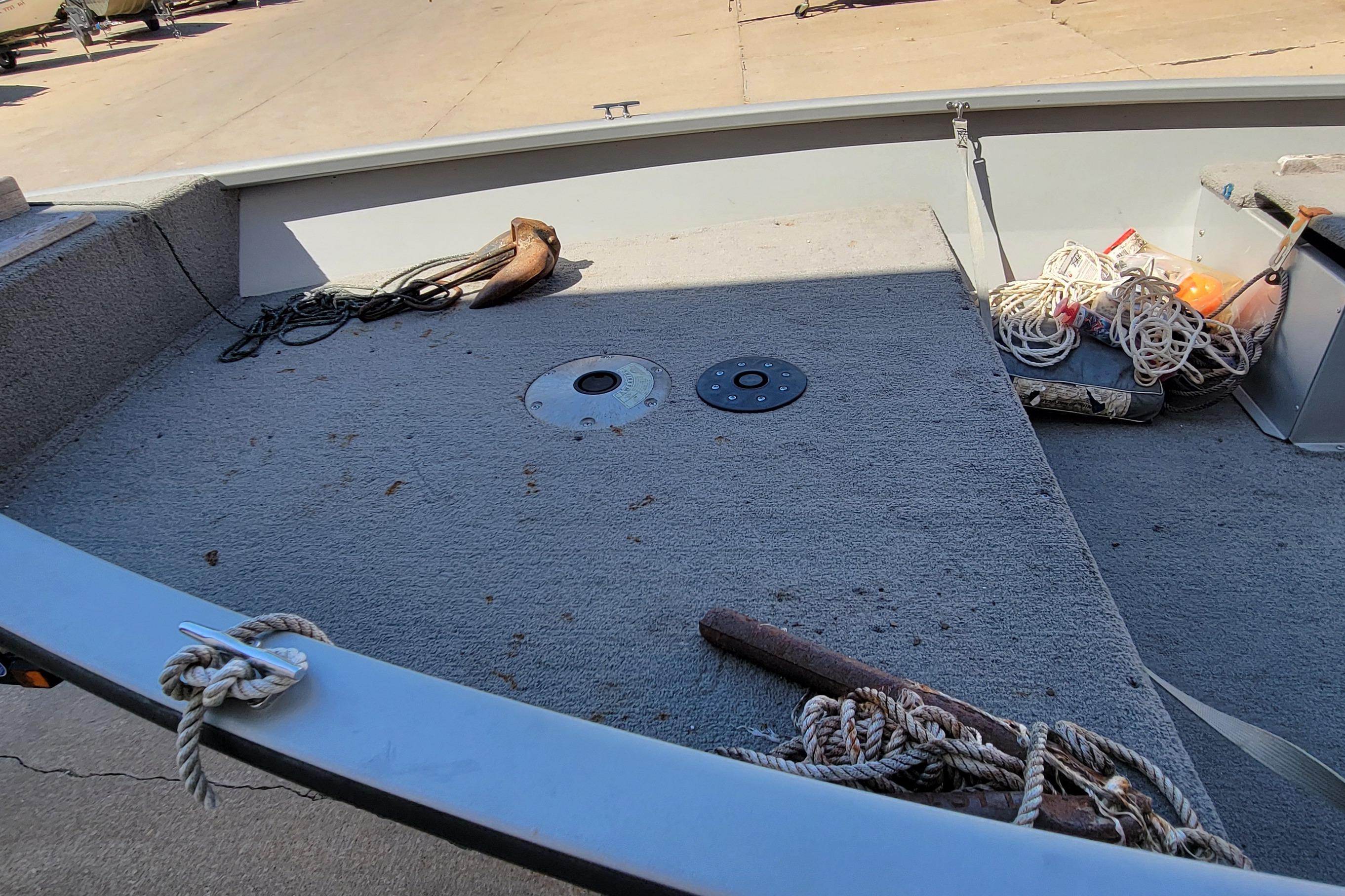 2010 Tracker Guide V 15 Laker boat interior with ropes and anchor on deck.