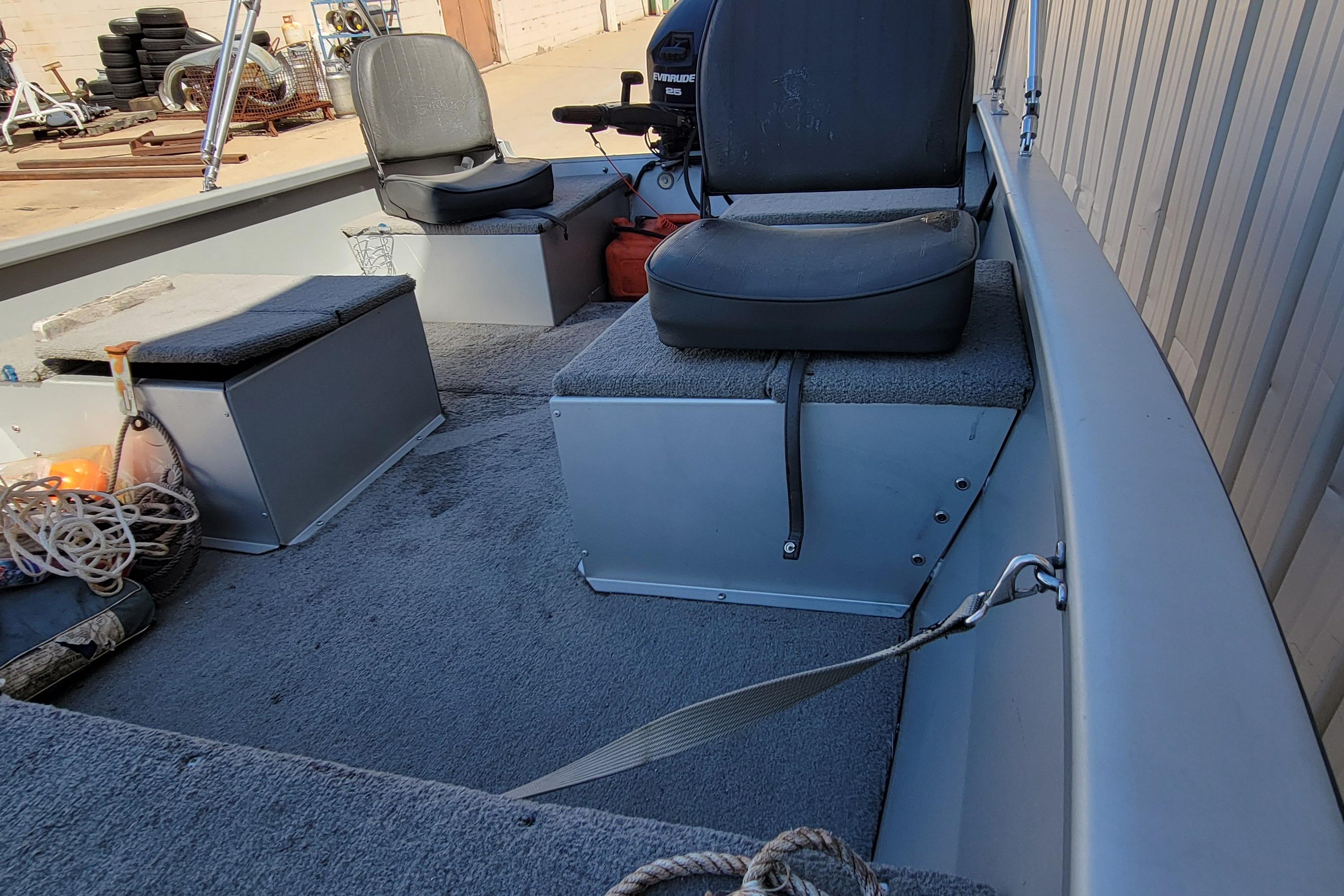 Interior of 2010 Tracker Guide V 15 Laker boat with seating and equipment.