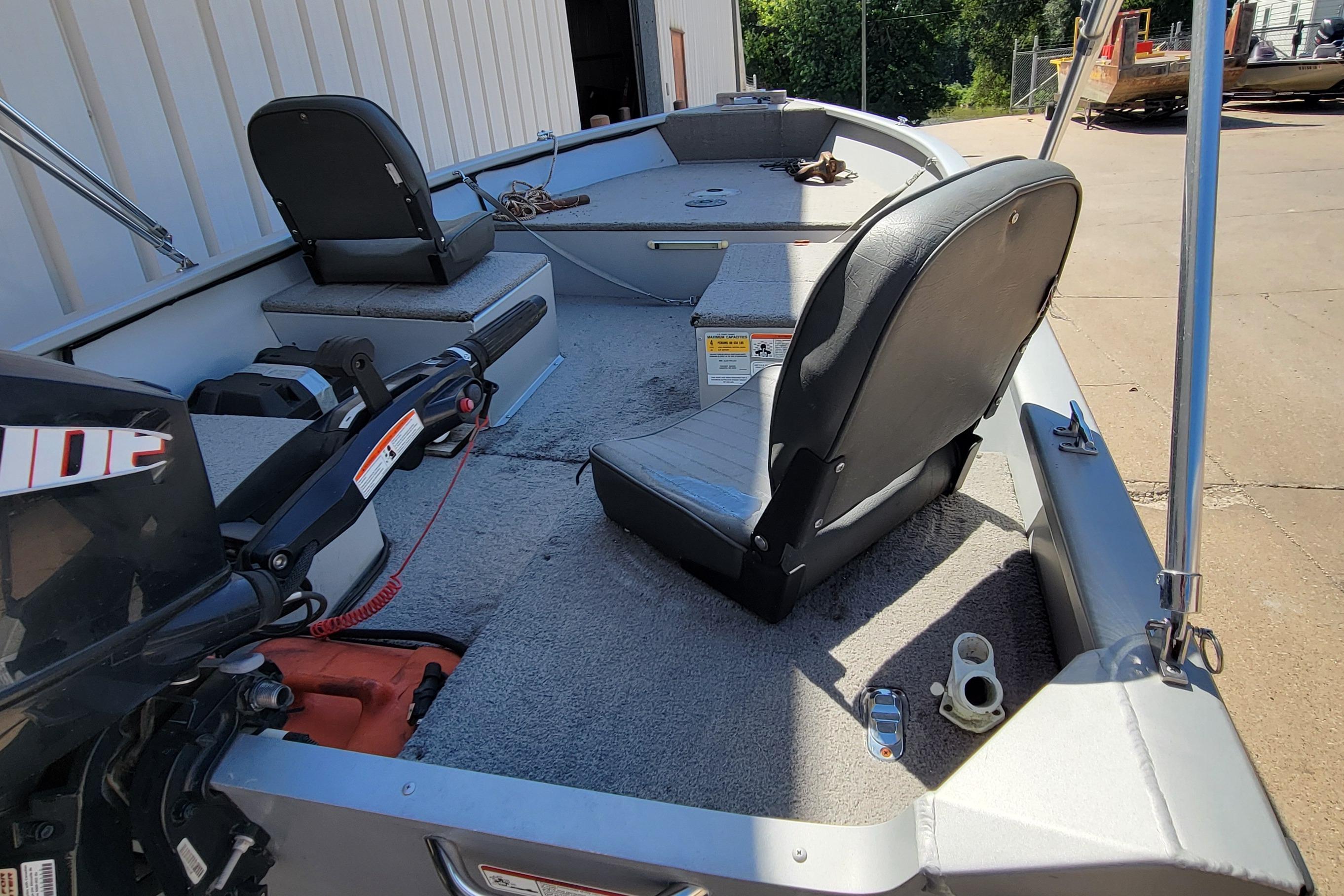 2010 Tracker Guide V 15 Laker boat interior with seating and motor.