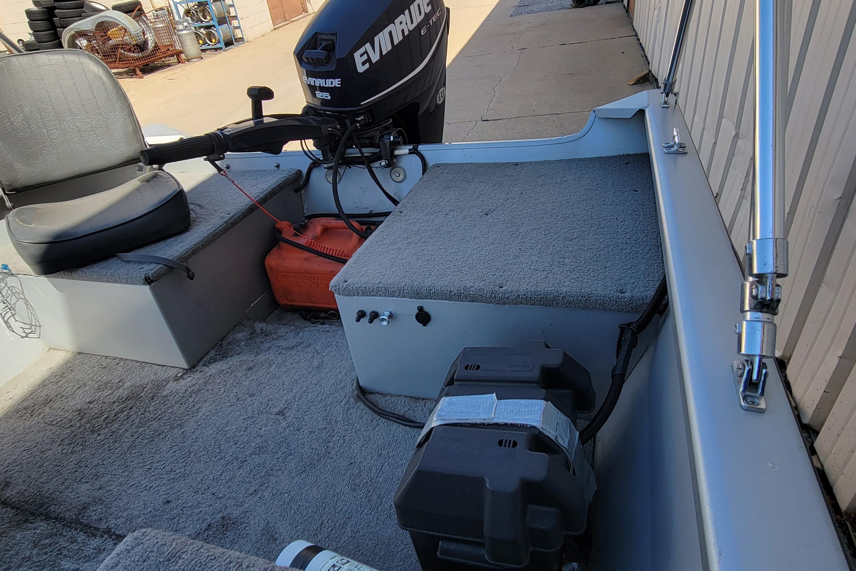 2010 Tracker Guide V 15 Laker boat interior with Evinrude motor and seating.