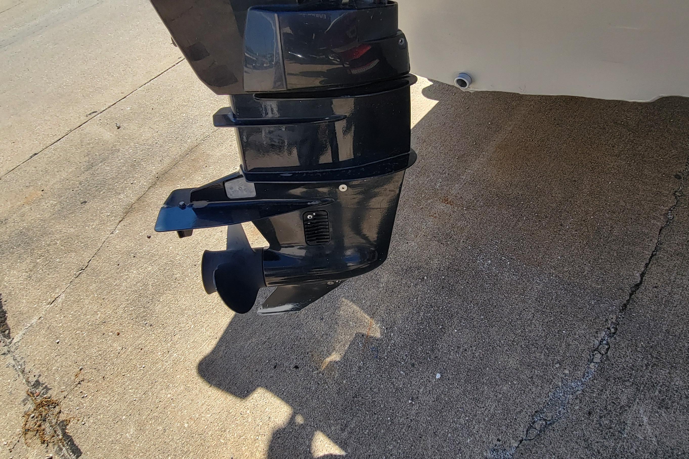2010 Tracker Guide V 15 Laker boat motor on concrete surface.