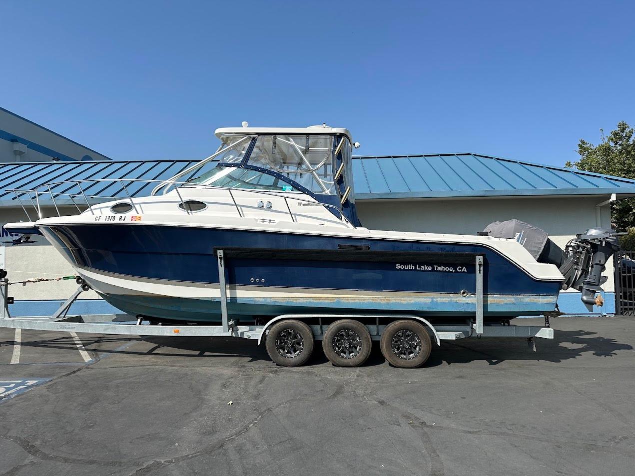 2006 Wellcraft 290 Coastal boat on trailer, South Lake Tahoe, CA, sunny day.