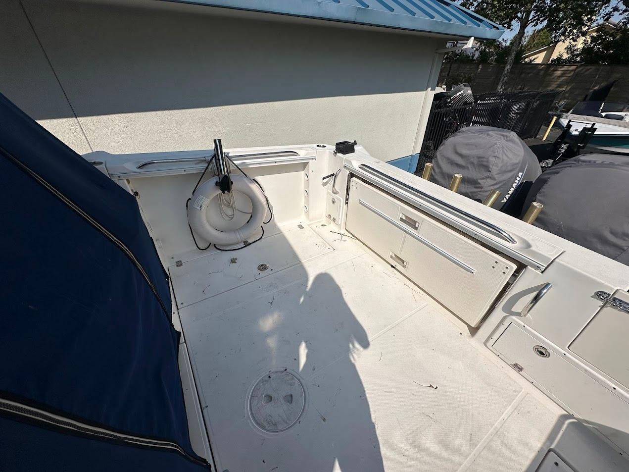 2006 Wellcraft 290 Coastal boat deck with storage compartments and life ring.