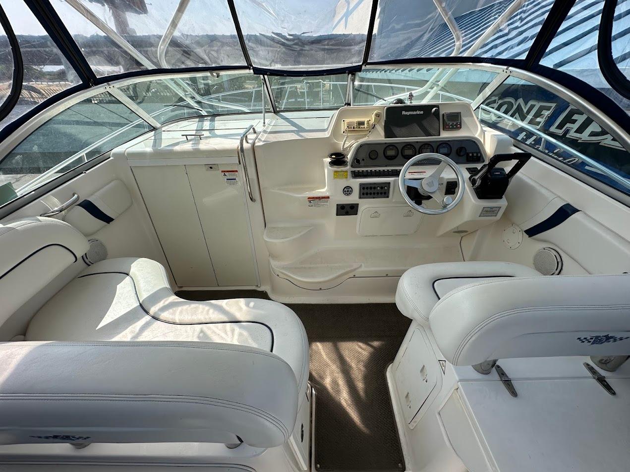 2006 Wellcraft 290 Coastal boat interior with white seating and modern dashboard.
